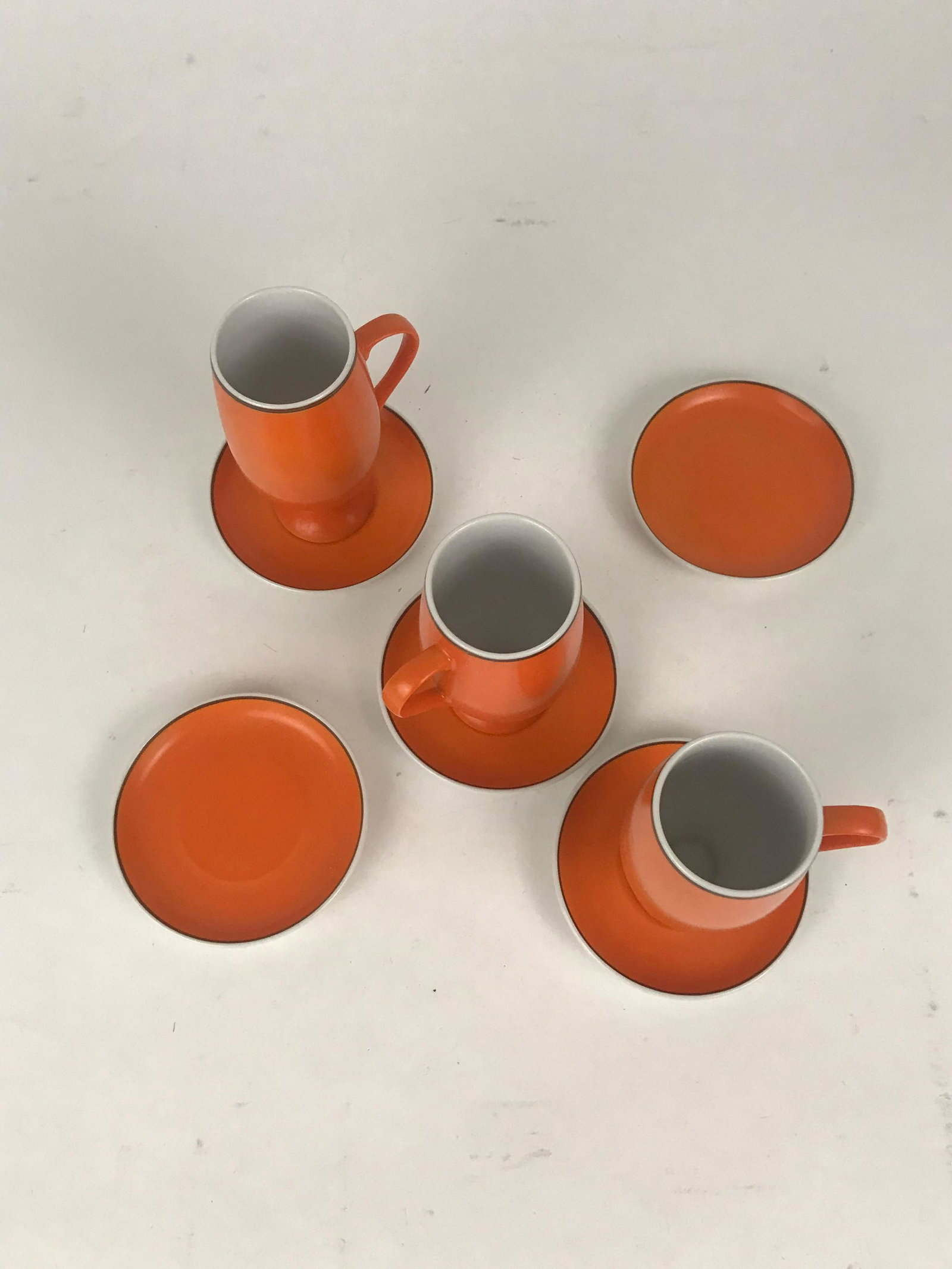 8 Pc. Orange Cups & Saucers by Lagardo Tackett: 8 Pc. Orange Cups & Saucers by Lagardo Tackett. There are 3 cups, and 5 saucers. Saucers 3.5", cups 1.75" x 4"