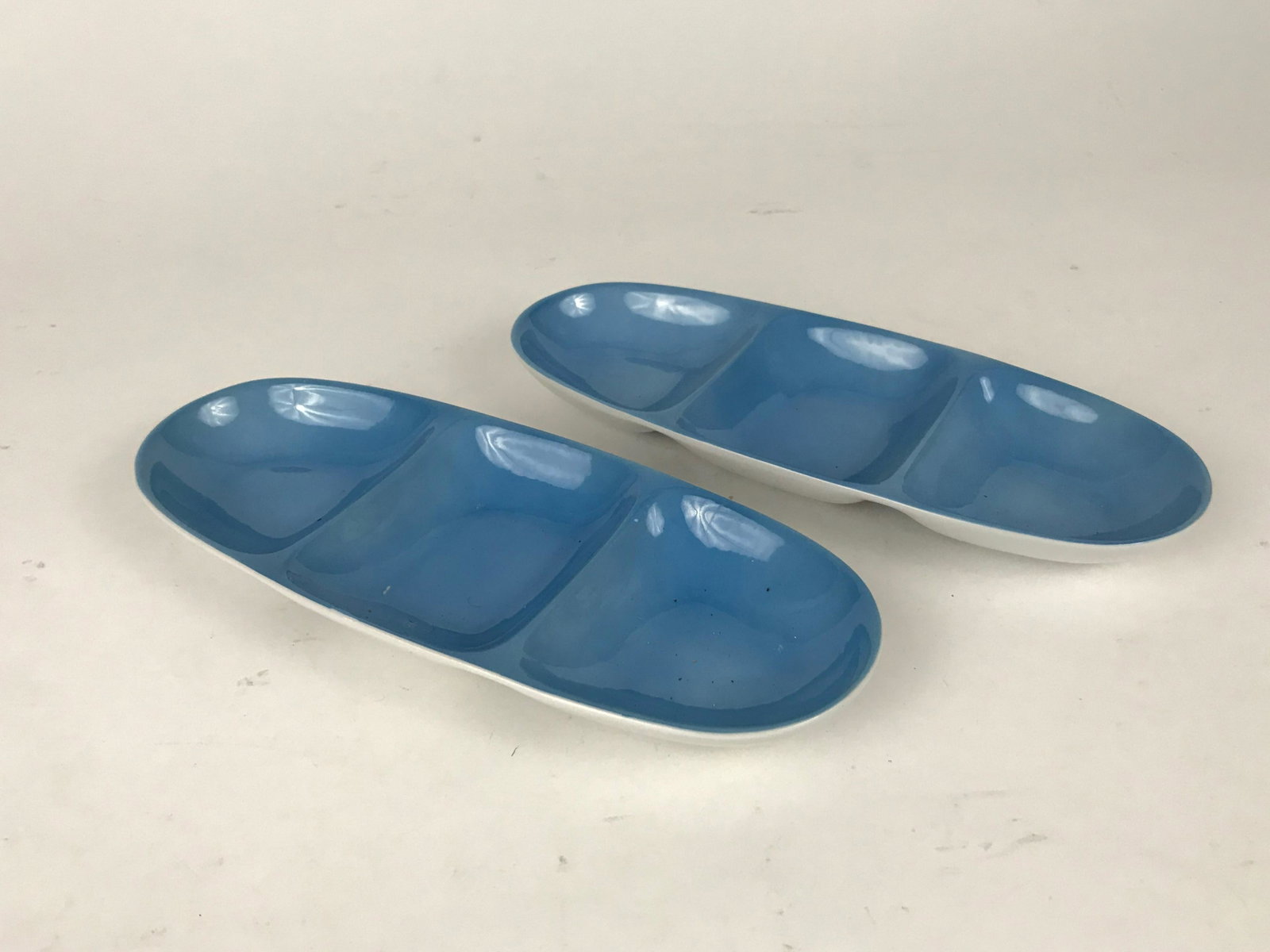 2 Pc. Blue Relish Trays by Lagardo Tackett: Pair of blue porcelain divided well relish trays by Lagardo Tackett. 9.75" x 4"