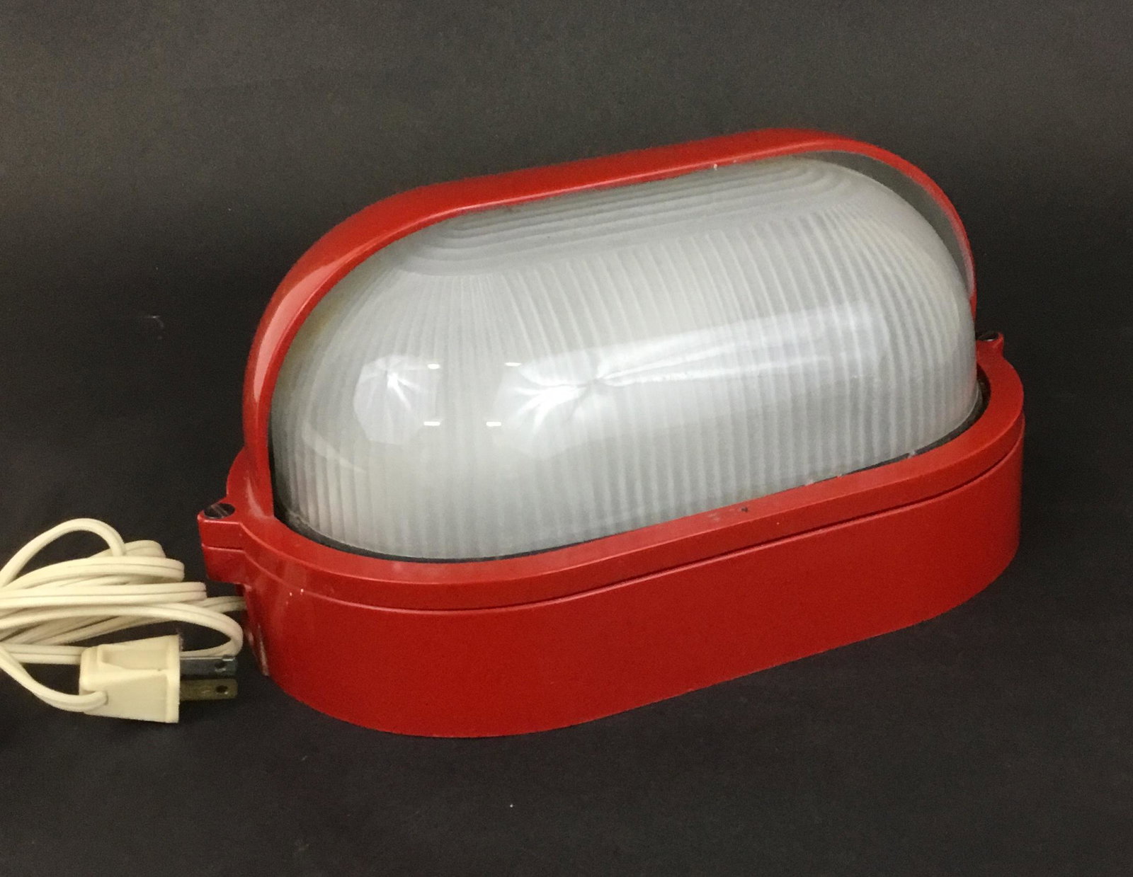 Goccia Italy 1970s Light Fixture: It works! Super cool 70's Italian wall light in red plastic and ribbed glass. Marked on the back Brevetto Depositato 200 W Goccia Offlaga (Bs) Italy. Measures 11" long 6" deep and 5" tall.