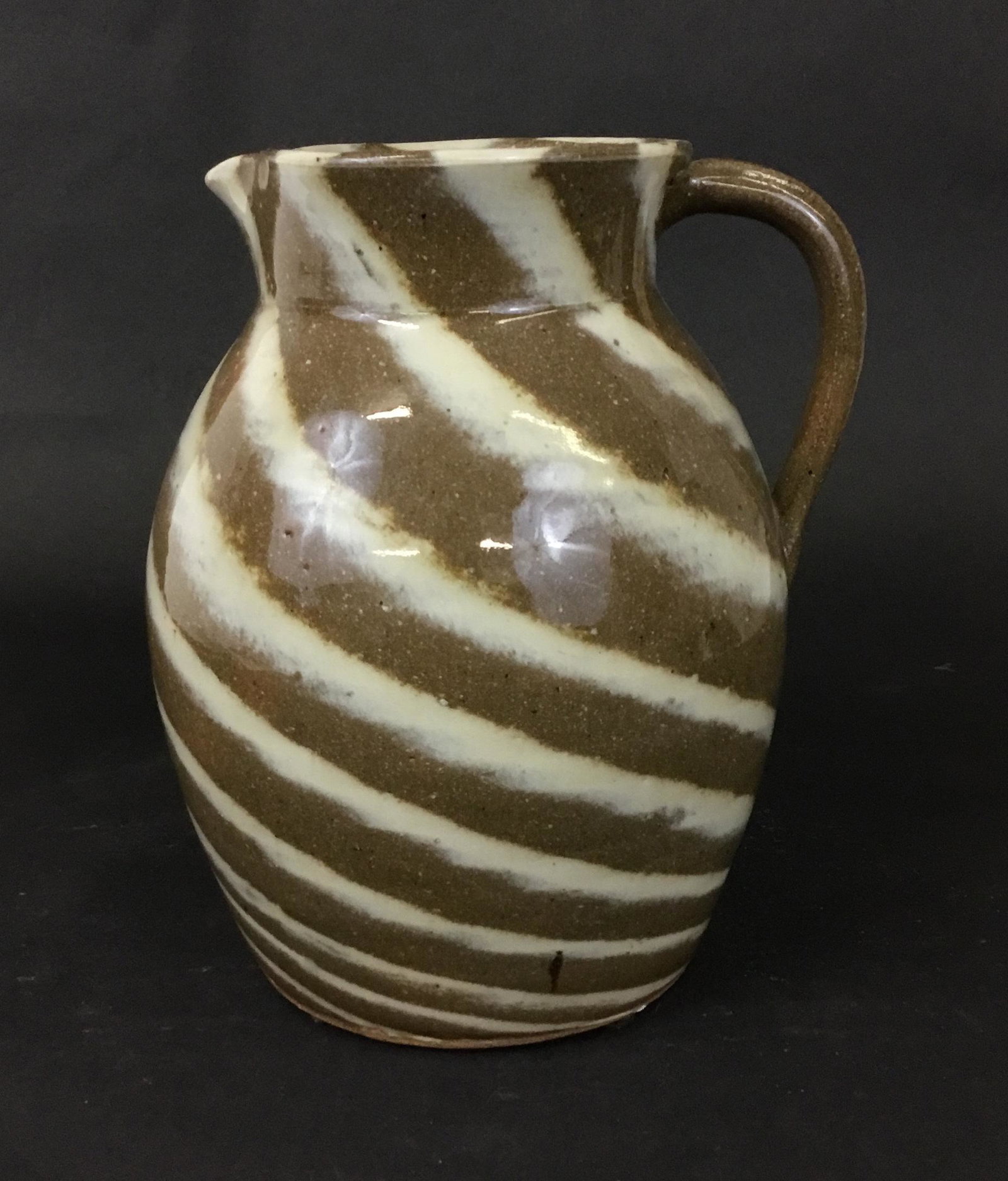 Charles Lisk Pottery Pitcher NC: This statement ceramic pitcher is by Charles Lisk of Vale NC. Well known for his distinctive face jugs and noted for this stripe effect. This piece measures 7" across handle to spout and 8.5" tall. Ni