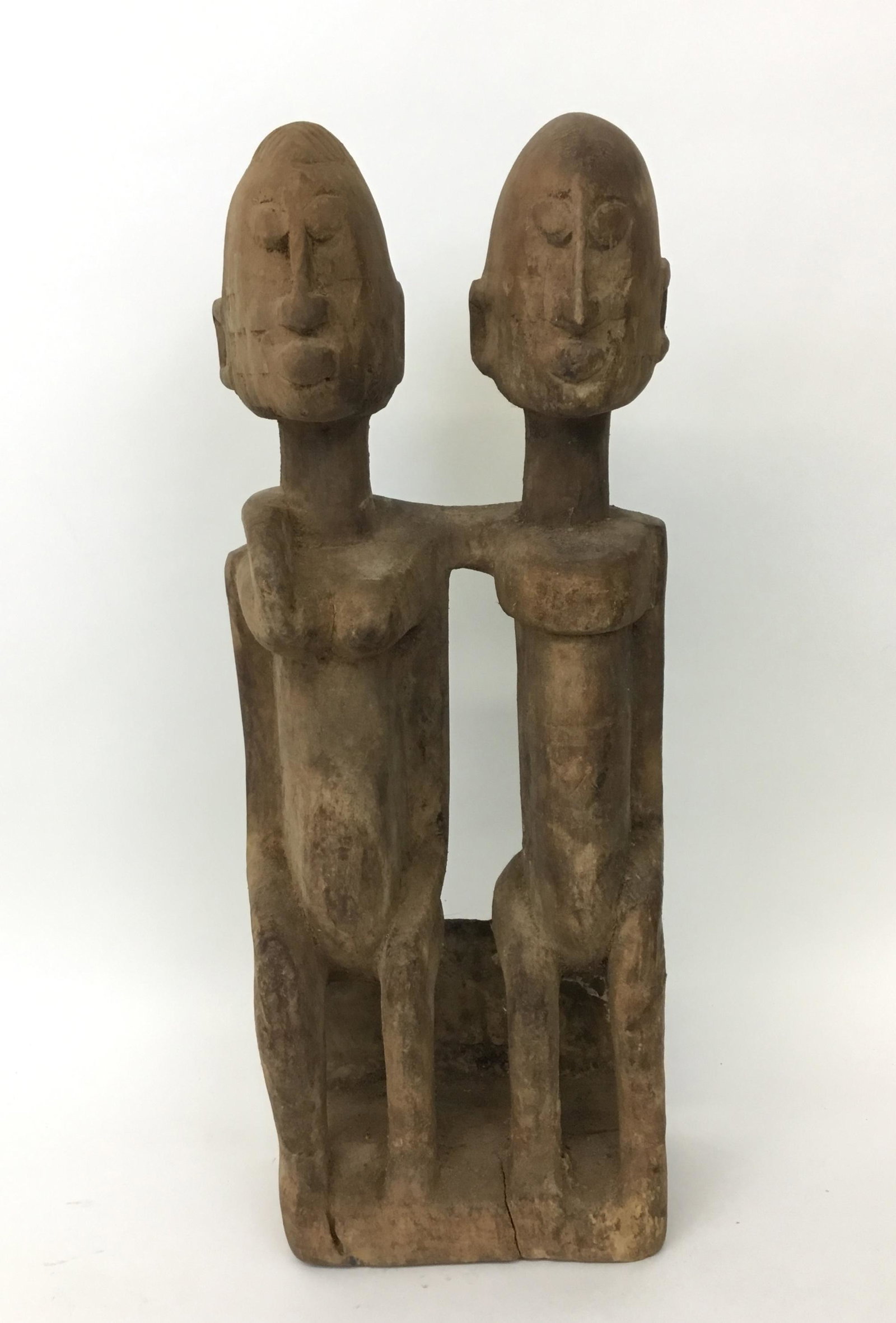 African Carving Dogon Style Two Figures: Dogon style wooden carved pair of figures sitting. Mali Africa. Primordial couple depiction. measures 5.5" wide and 14.75" tall.
