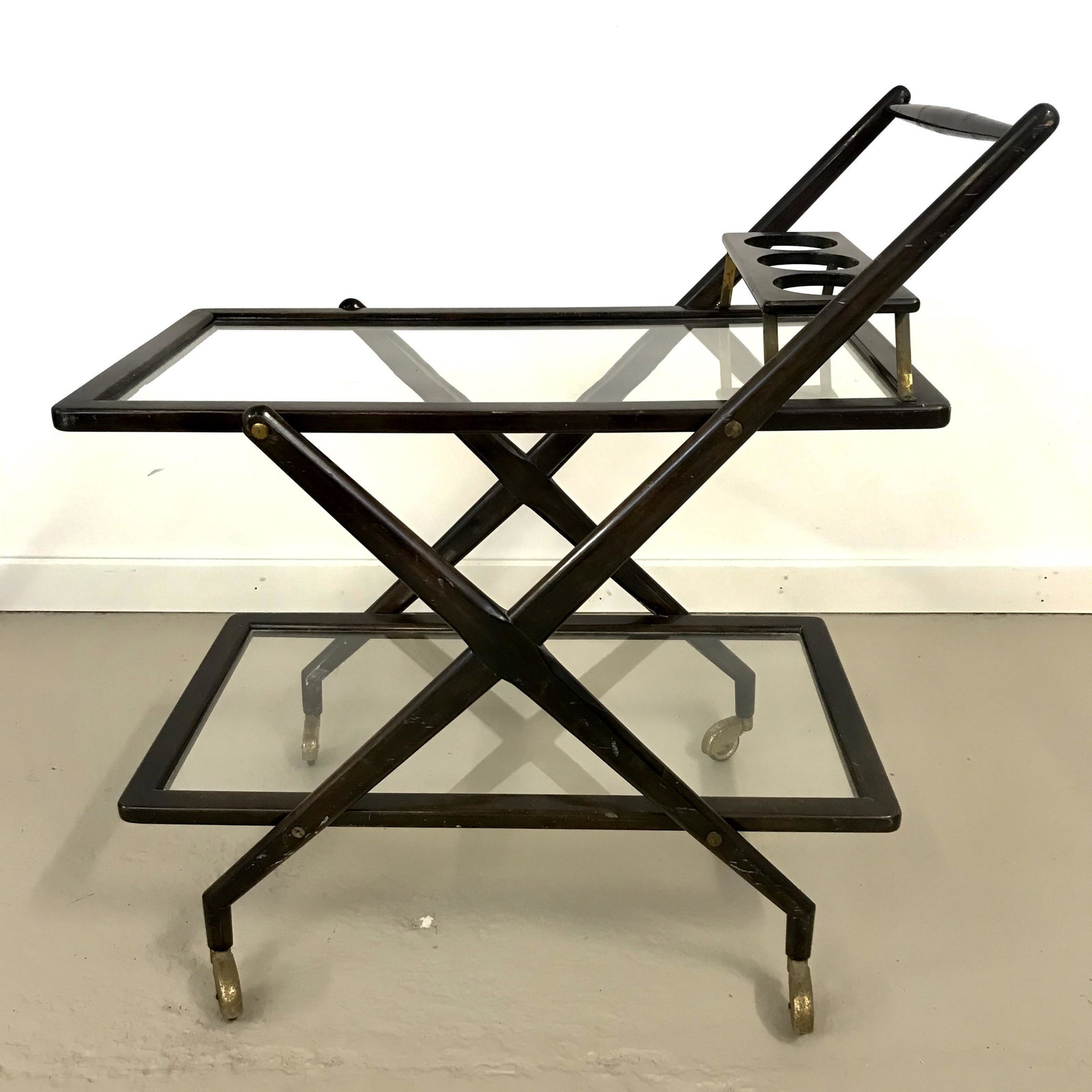 Mid Century Italian Bar Cart Casare Lacca: walnut 1950's bar cart Two tier rolling cart wood frame with glass shelves and brass accents 31" x 18" 33"h