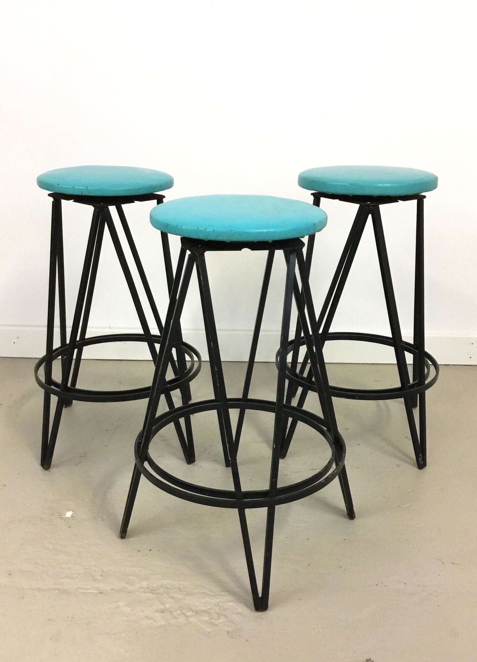 Three Vintage Iron Swivel Stools attr Weinberg: Set of 3 vintage square-bar iron swivel stools attributed to Frederick Weinberg. Vinyl upholstered seats in vintage condition. 16" base diameter, 22.5" tall. Seat is 10.5" across.