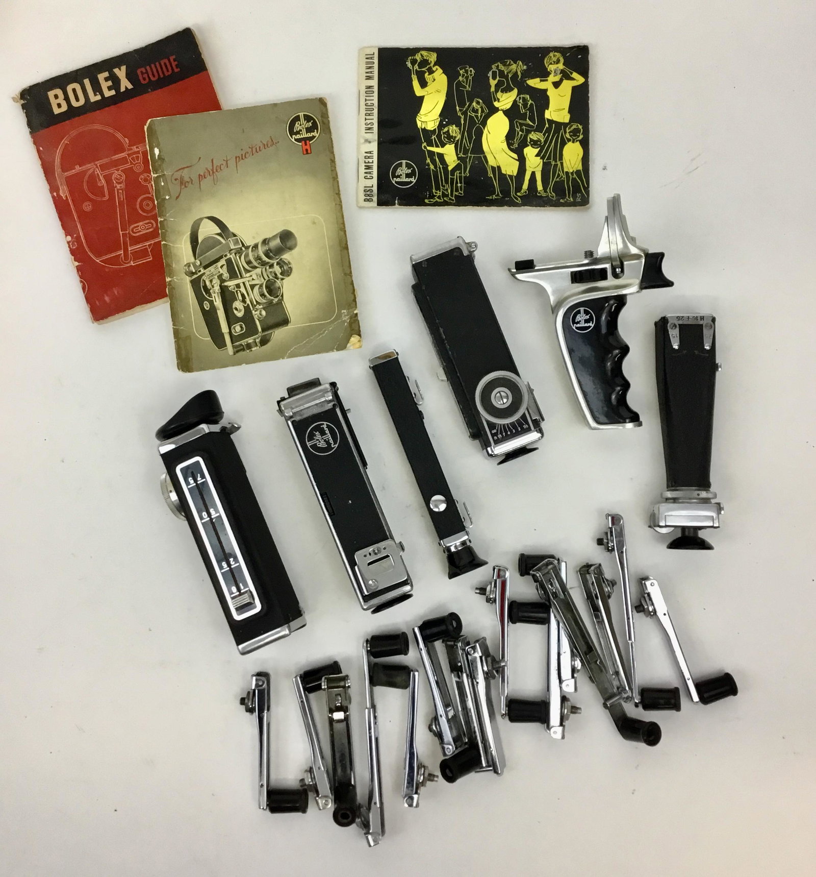 Vintage Bolex Viewfinders and Winding Handles, Ephemera: Viewfinders and winders, and a pistol grip for Paillard Bolex movie cameras plus some Bolex paperwork.