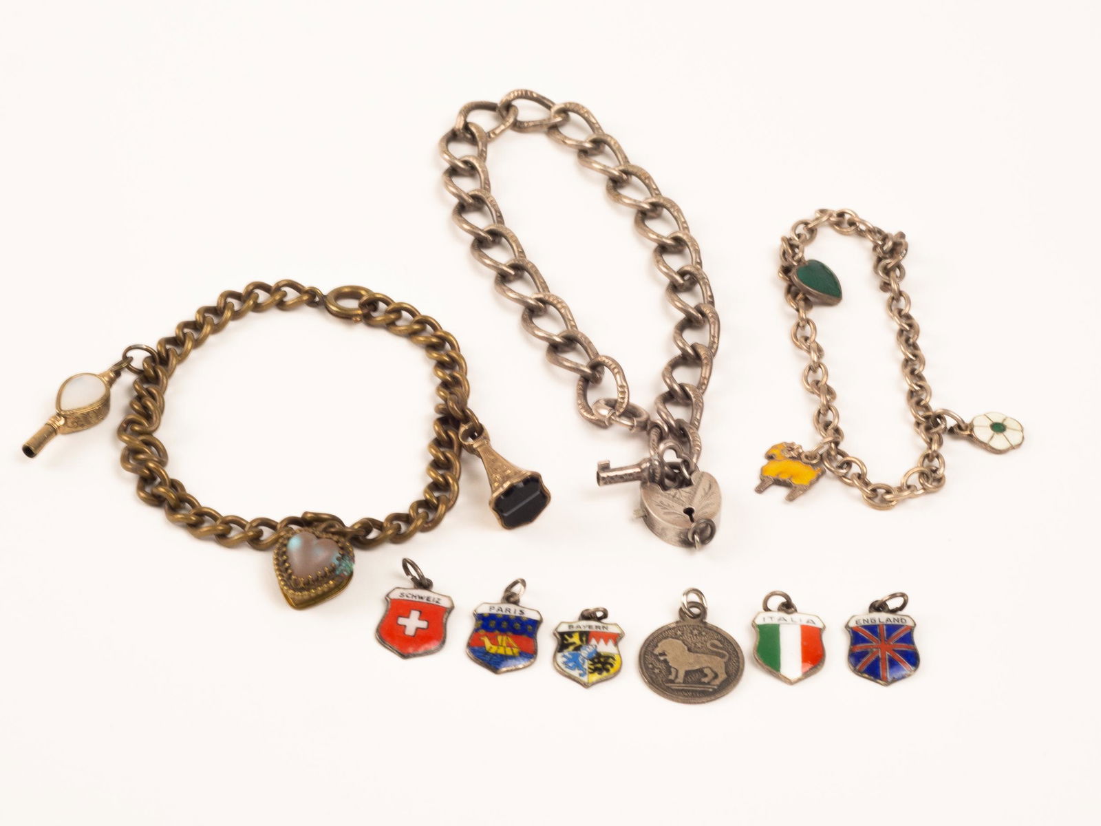 Vintage Charm Bracelets and Charms: Sweet vintage bracelets and charms. The heart and key bracelet is silver. As is the smallest one with the Danish enamel charms. The loose charms are a mix, many are 835 silver.