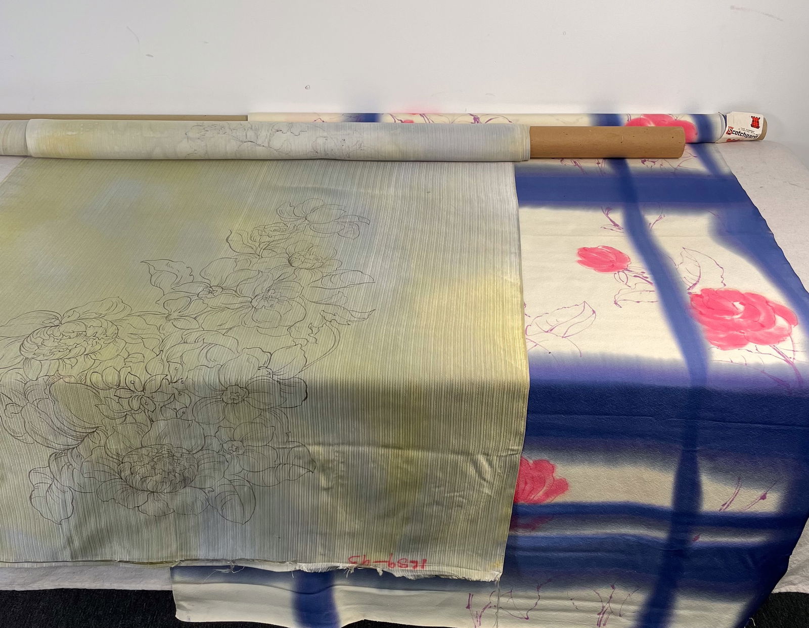 Lot #7 Fabric - Hand Painted Japanese Silk: Two different partial bolts of hand painted japanese silk fabric. One has an original hang tag as shown. Both partial bolts measure 36" wide.