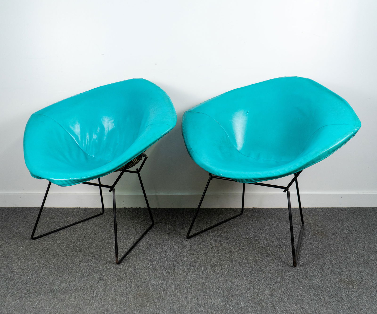 Bertoia Diamond Chairs for Knoll: Two Bertoia diamond chairs for Knoll Associates, with the Knoll label on the blue padded liner. 34"w x 27"d x 30"h