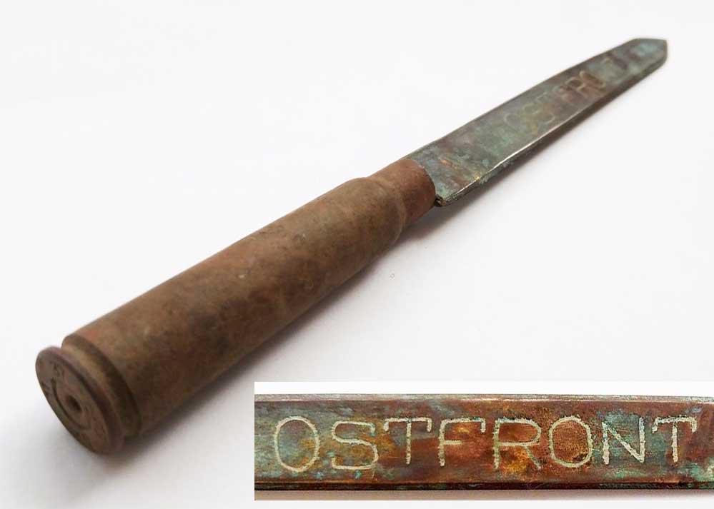 GERMAN WW2 KNIFE w. SHELL ROUND CARTRIDGE: ORIGINAL GERMAN WW2 KNIFE with SHELL ROUND CARTRIDGE For Opening Envelopes. Made of shell round Cartridge. Trench art. Engraving is done using old technique: Ostfront. SIZE: 172 x 11 x 10 mm (6.77 x 0