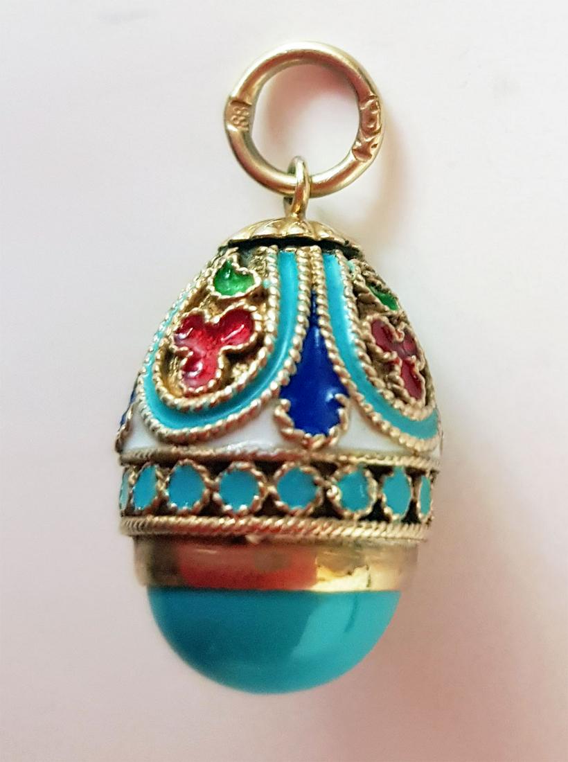 FABERGE - RUSSIAN SILVER & ENAMEL EGG PENDANT: FABERGE - RUSSIAN SILVER and ENAMEL EGG PENDANT The egg has a decorative pattern, covered with different color enamel and adorned with gilded elements. Natural stone is used for the base of the egg. I