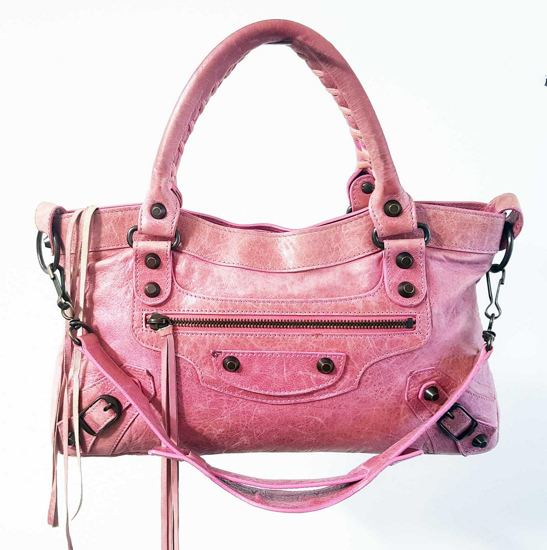 AUTHENTIC BALENCIAGA BUBBLE GUM PINK HANDBAG: AUTHENTIC BALENCIAGA BUBBLE GUM PINK CLASSIC WORK BAG HANDBAG Brand: BALENCIAGA. Style Number: â„– 1574 T. Cereal Number: 103208. COLOR: Pink, Bronze hardware. MATERIAL: Leather. Lining: Canvas. 