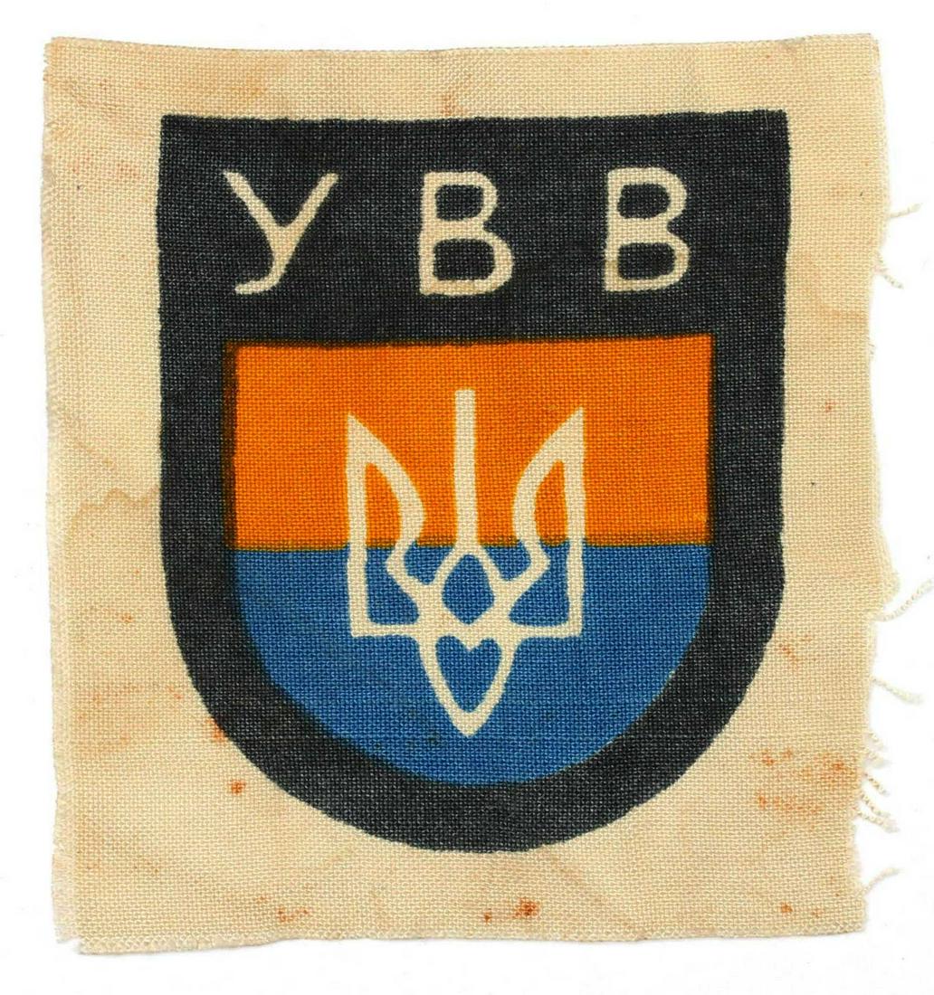 GERMAN WW2 UKRAINIAN YBB VOLUNTEER'S SLEEVE SHIELD: GERMAN WW2 UKRAINIAN YBB VOLUNTEER'S SLEEVE SHIELD, 1941-1945 Woven linen base with the official, screen printed pattern consisting of a flat topped, rounded bottom, field-grey, shield shaped base wit