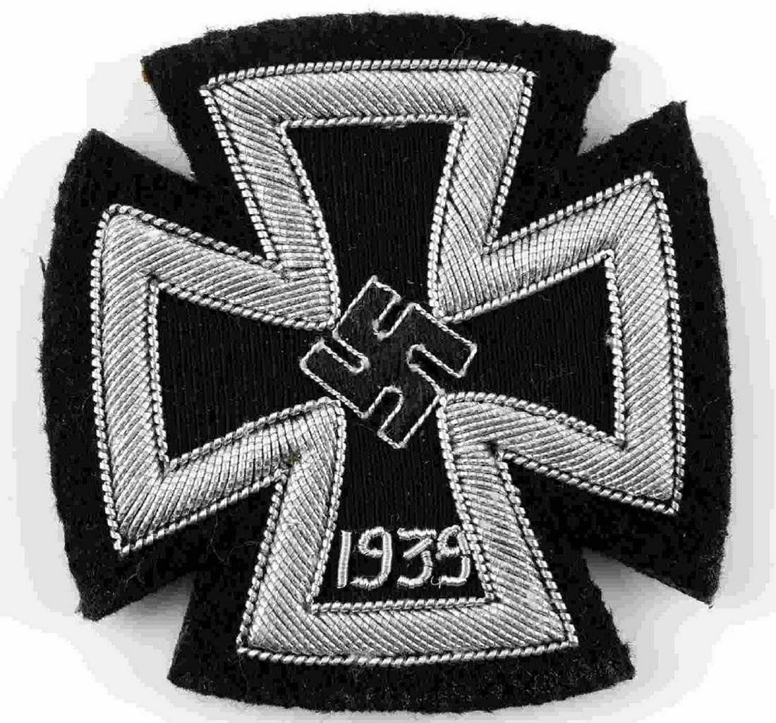 GERMAN WW2 IRON CROSS 1st CLASS EMBROIDERED: GERMAN WW2 IRON CROSS 1st CLASS EMBROIDERED Cloth patch with the image of the Iron Cross 1st Class upon it. Silver bullion wire of two different gauges, with a more common narrow gauge wire on the '19