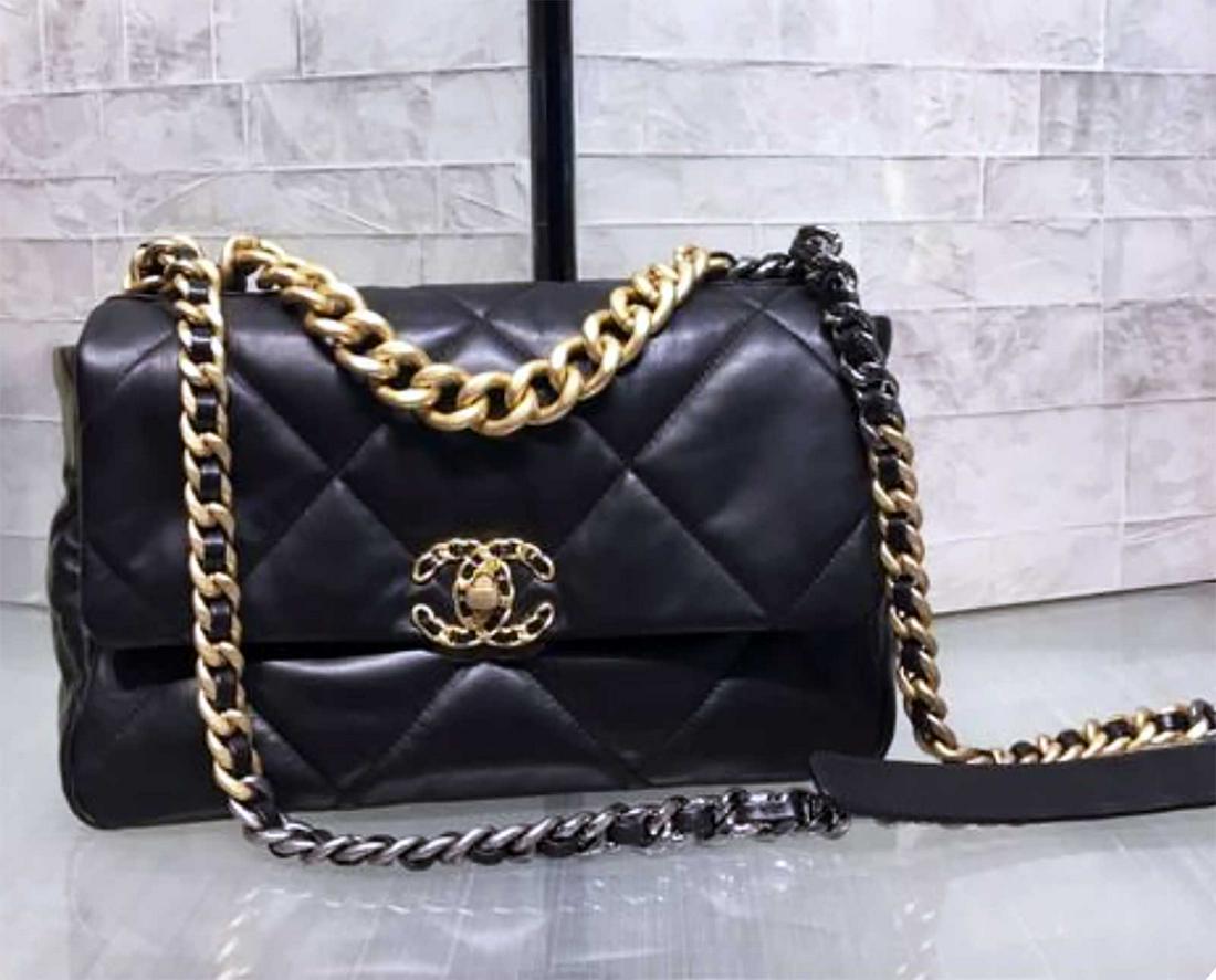 CHANEL 19 FLAP BAG BLACK: CHANEL 19 FLAP BAG LAMBSKIN GOLD-TONE, SILVER-TONE & RUTHENIUM-FINISH METAL BLACK REORDERS. First seen on the runway of the F/W 2019 ready-to-wear collection created by Karl Lagerfeld and Virginie Via