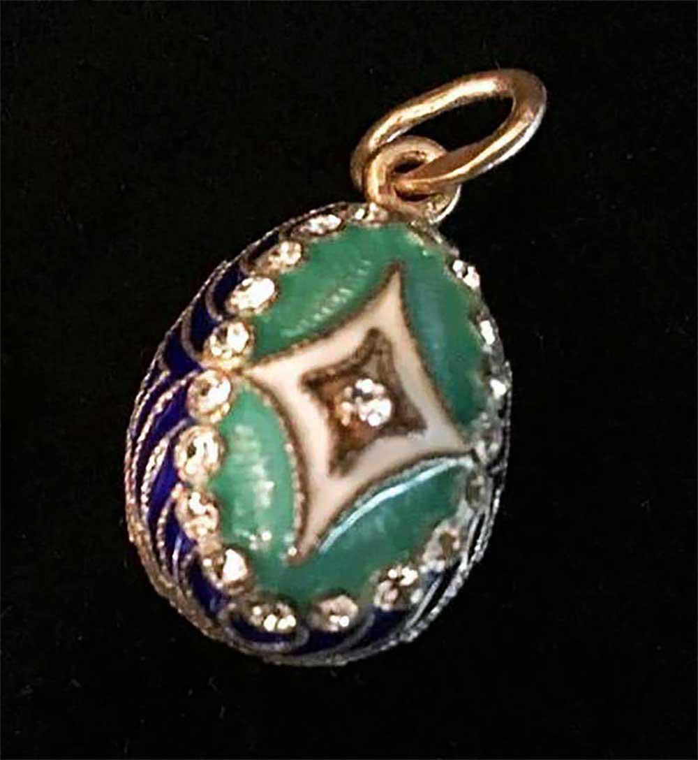 RUSSIAN SILVER EGG PENDANT: RUSSIAN SILVER PENDANT COATED with ENAMEL and GOLD In the manner of Faberge, Gilt Silver, Enamel and Rhinestone Egg Form Pendant. The egg has a decorative pattern, covered with different color enamel 