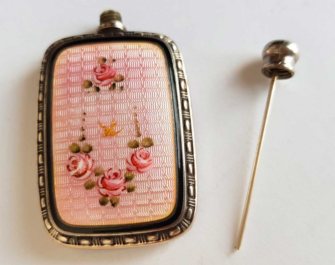SILVER ENAMEL PERFUME FLASK, FABERGE STYLE: RARE SILVER and ENAMEL PERFUME FLASK Silver and enamel perfume flask is in pink guilloche enamel with floral decoration. Marked. Early 20th C. CONDITION: The item is described to the best of our knowl