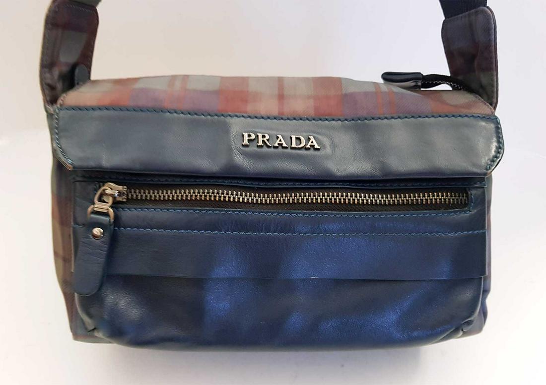 PRADA SCOZZENS MESSENGER BAG TESSUTO/SAFFIANO: PRADA TESSUTO SCOZZENS SAFFIANO MESSENGER BAG BROWN/GREEN A brown and green check nylon Tessuto cross-body bag with dark green leather trim. Features a long, adjustable nylon shoulder strap and a larg