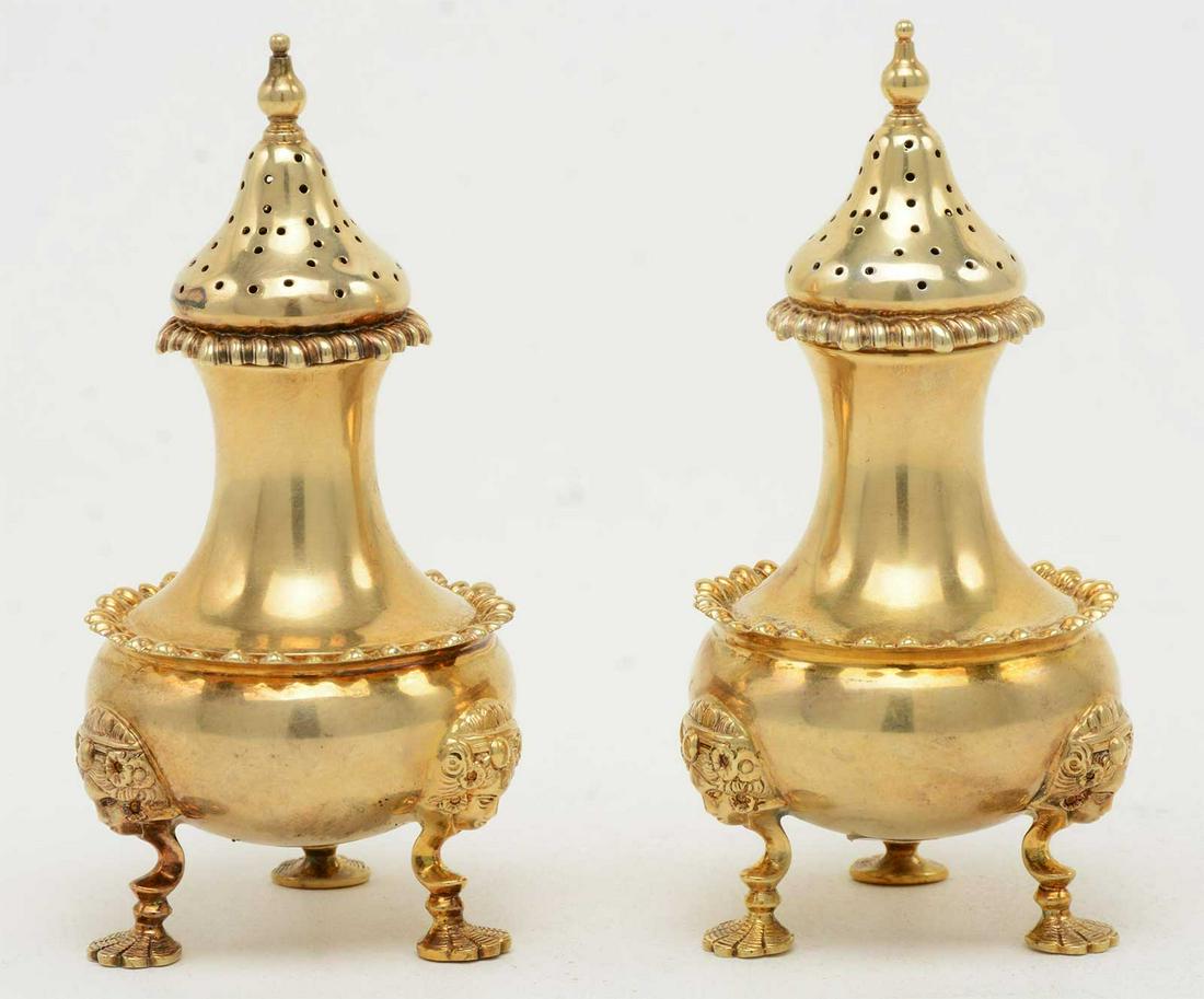 PAIR of RUSSIAN ANTIQUE SILVER SHAKERS: PAIR of RUSSIAN ANTIQUE SILVER SHAKERS Pair of Antique gilt Russian silver salt and pepper shakers. Figural mask and shell pad feet. Gadrooned borders. Hallmarked on base of feet.84 mark. Faberge make