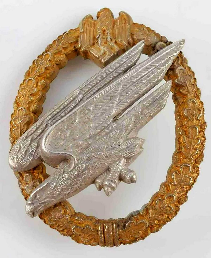 GERMAN WWII 3rd REICH LUFTWAFFE PARATROOPER BADGE: RARE GERMAN WWII 3rd REICH LUFTWAFFE PARATROOPER BADGE Third Reich Luftwaffe paratrooper badge produced by C.E. Juncker. Fallschirmjager eagle riveted on oak leaf wreath. Reverse marked C.E. Juncker. 