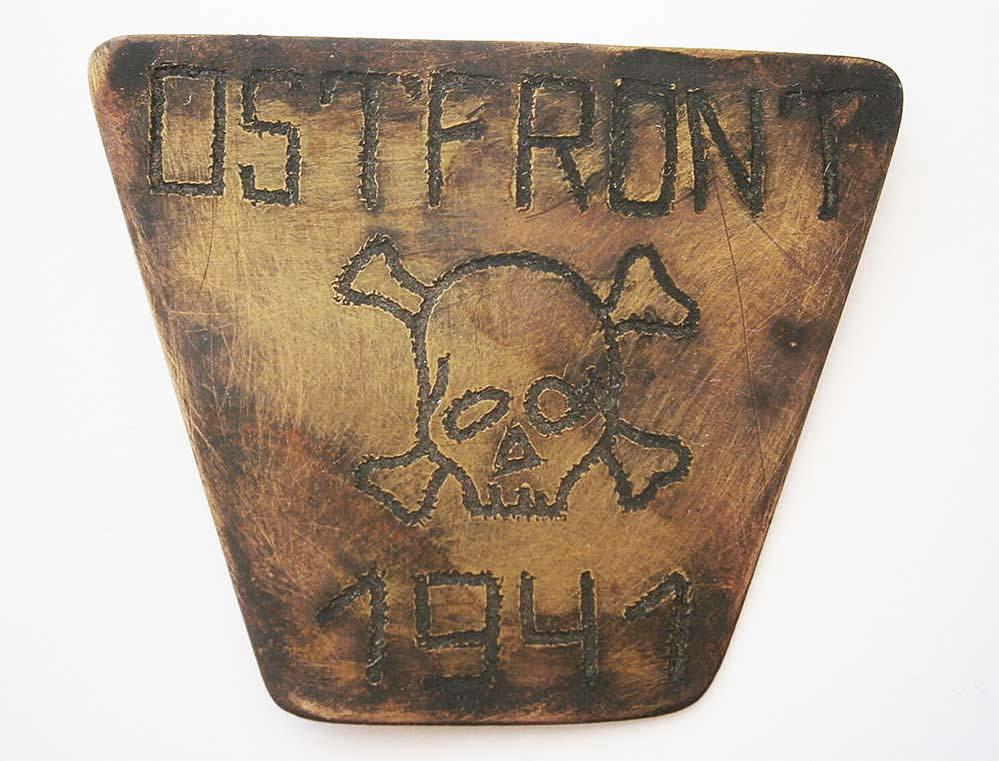 GERMAN WW2 BADGE with SKULL & BONES, OSTFRONT 1941: GERMAN WW2 BADGE with SKULL and BONES Trench art from Ostfront, 1941. The Bronze badge is engraved with Skull and BONES and word: Ostfront. CONDITION: The item is described to the best of our knowledg