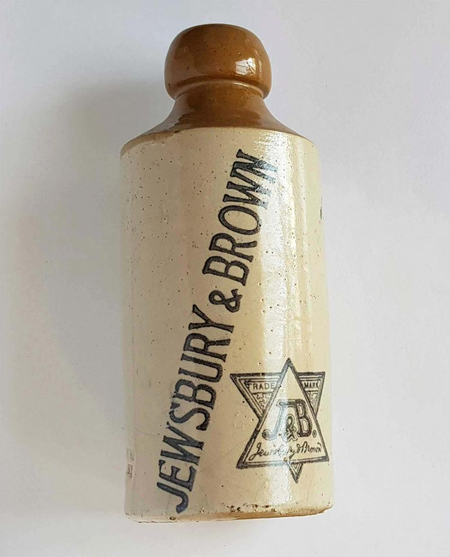 CERAMIC LIQUOR BOTTLE FOR JEWSBURY with DAVID STAR: JEWISH CERAMIC LIQUOR BOTTLE FOR JEWSBURY & BROWN with STAR of DAVID American, circa early 20th century. Imprinted with a Jewish star of David. Brown in color. Marked. CONDITION: Overall condition is