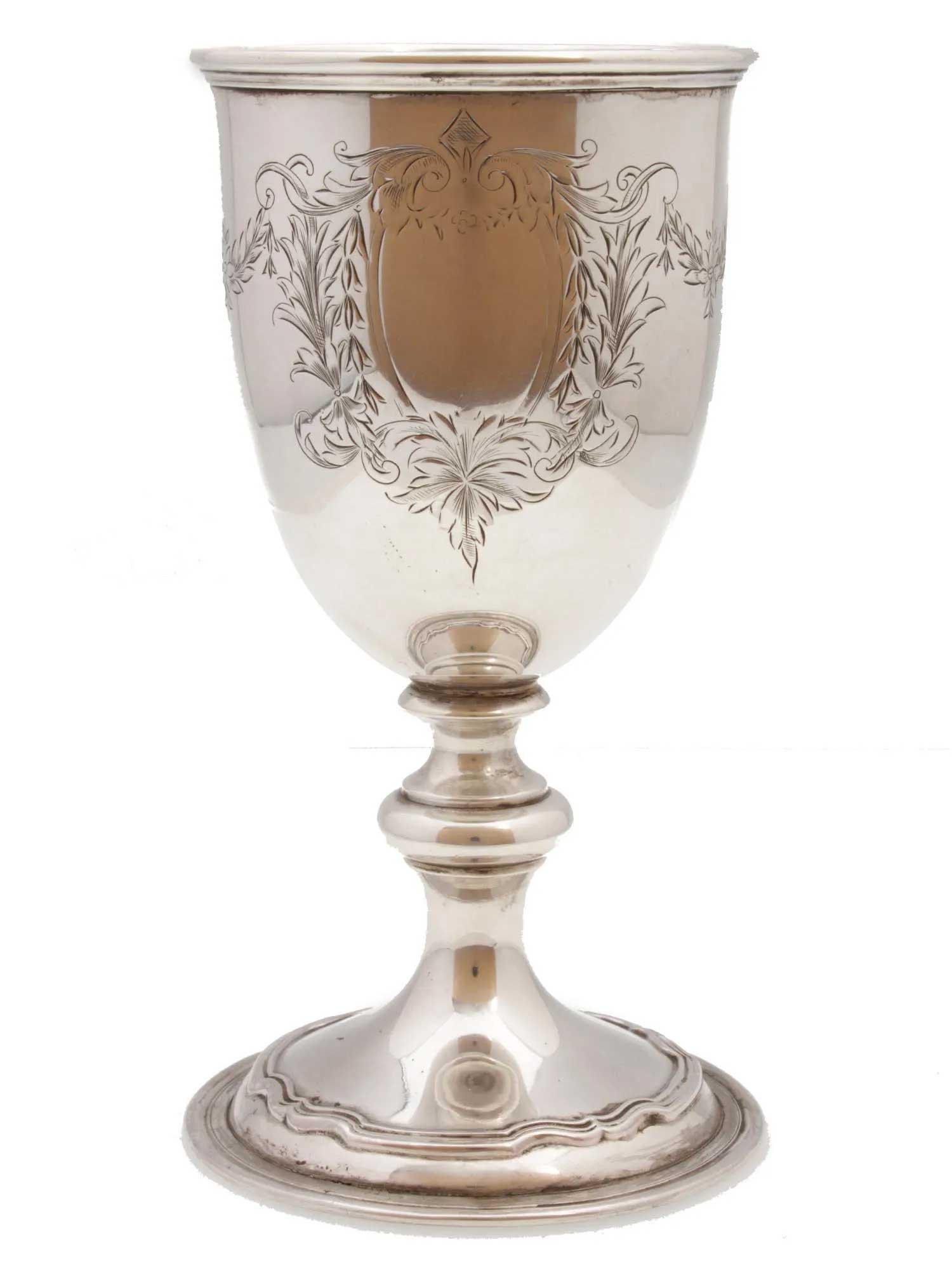 ANTIQUE AMERICAN JEWISH SILVER KIDDUSH CUP: RARE ANTIQUE AMERICAN JEWISH SILVER KIDDUSH CUP, JUDAICA An antique sterling silver Kiddush Cup by Reed and Barton. The surface is engraved with floral motifs. HALLMARKS: manufacturer's emblem, STERLI