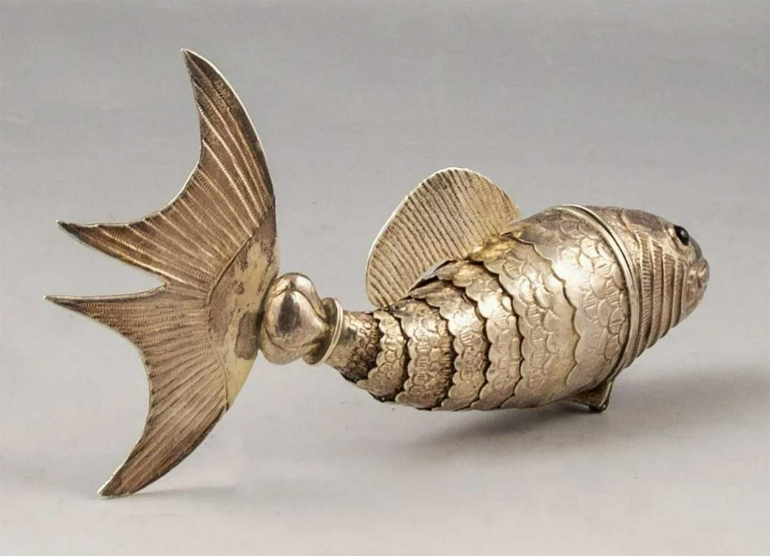 JUDAICA SILVER BESAMIM HAVDALA SPICE CONTAINER: JUDAICA SILVER BESAMIM HAVDALA SPICE CONTAINER, 19th CENTURY Designed as a fish. Rare besamim spice container. Hallmarked. DIMENSIONS: 7 3/4 x 3 3/4 inches (19 x 10 cm). Weight: 109 grams. CONDITION: 