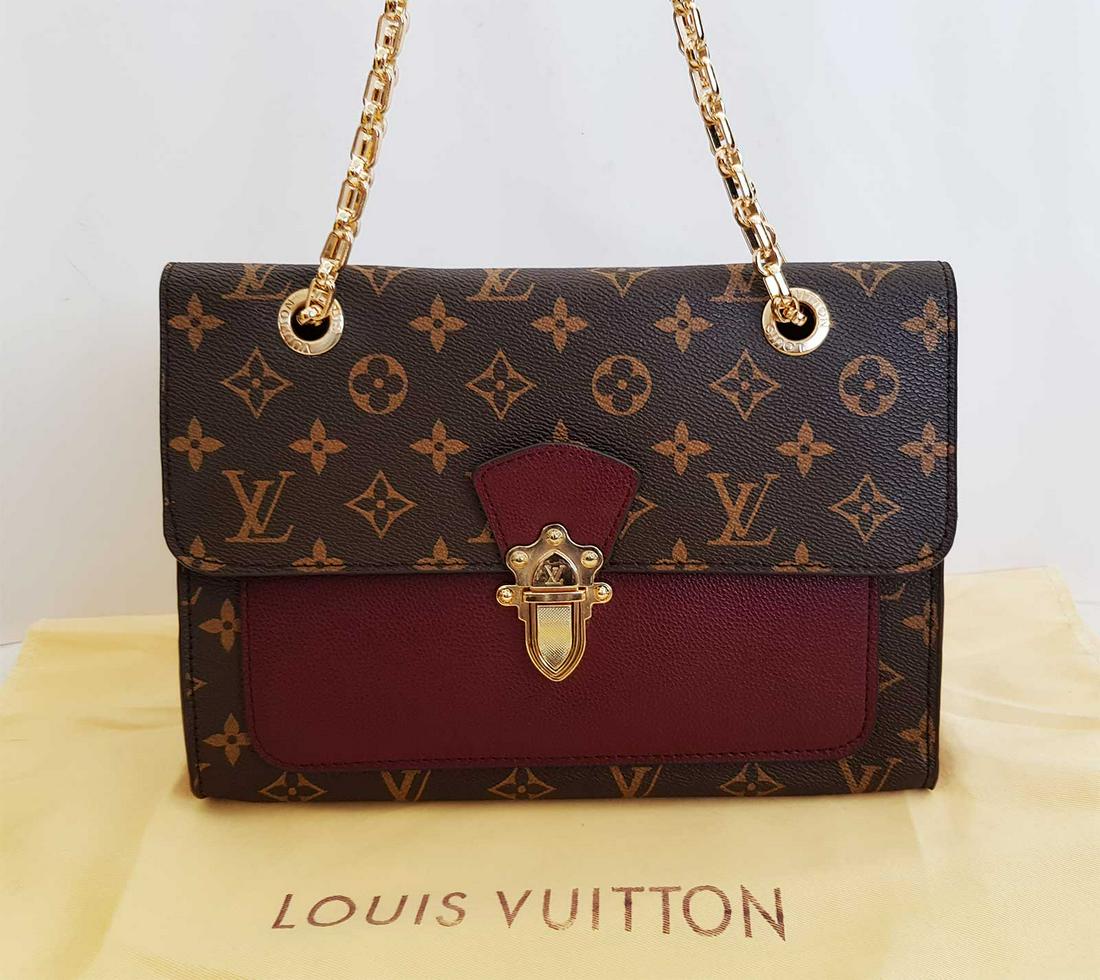 LOUIS VUITTON VICTOIRE BAG: LOUIS VUITTON VICTOIRE MONOGRAM CANVAS SHOULDER CROSSBODY BAG Louis Vuitton leather Victoire Bag which looks elegant, classy all rolled. Made from Monogram coated canvas with colorful calfskin, with m