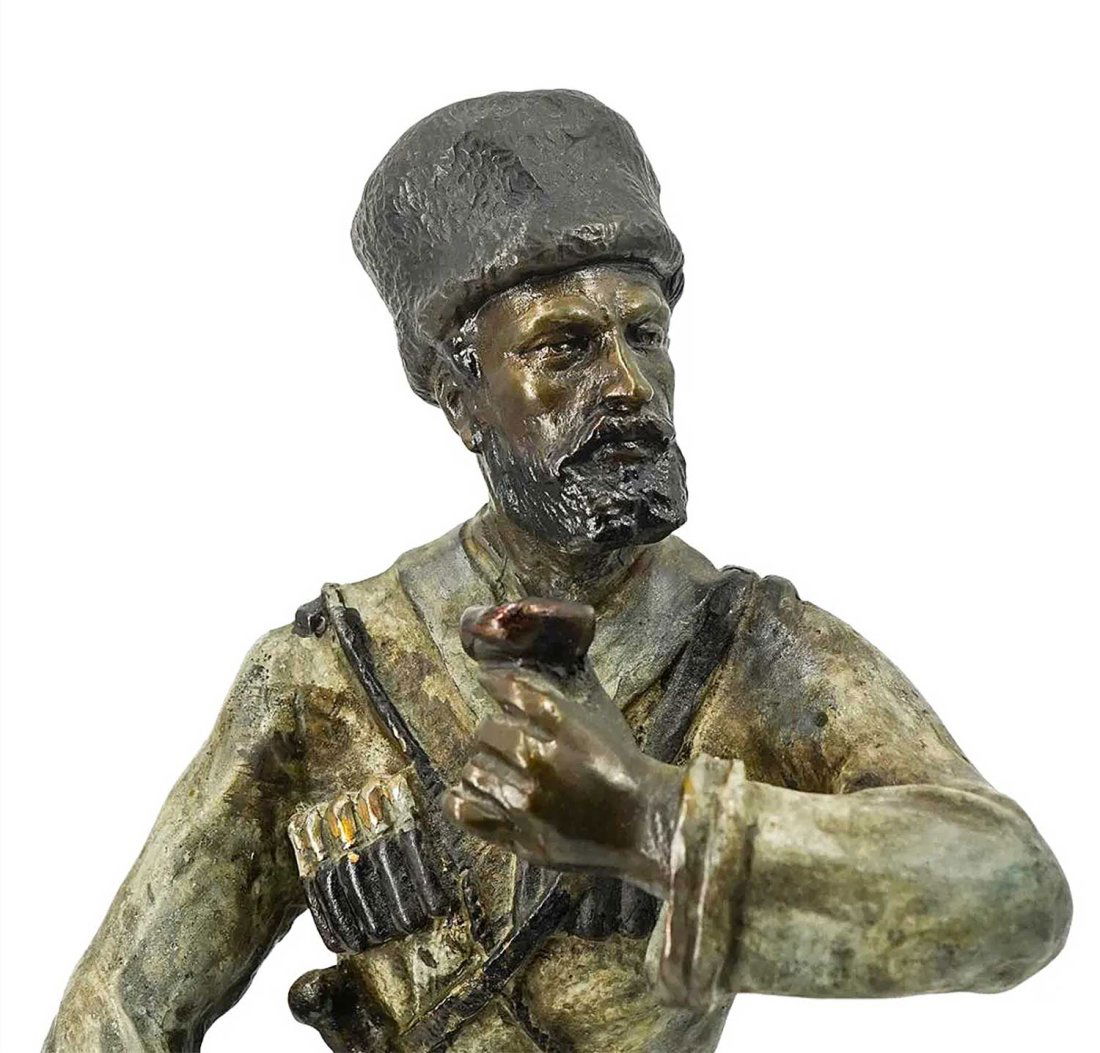 RUSSIAN ANTIQUE FIGURINE of COSSACK, LANCERAY: RUSSIAN ANTIQUE FIGURINE of BRONZE COSSACK, LANCERAY (LANSERE) Bronze sculpture made by Evgeny Aleksandrovich Lansere depicting a Cossack soldier holding a rifle in his right hand and a drinking vesse