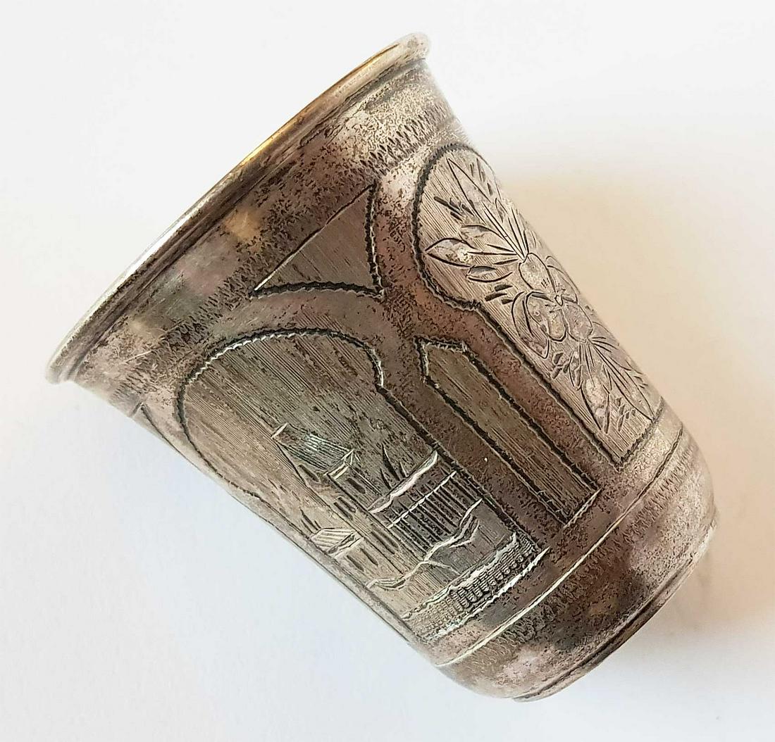 JEWISH SILVER KIDDUSH BEAKER, SHOT, CUP, 1877: RARE JEWISH SILVER KIDDUSH BEAKER, JUDAICA, SHOT, CUP, 1877 Russian silver kiddush beaker, cup. The exterior is adorned with etched village house view and floral patterns. HALLMARKS: Marked with a Sil