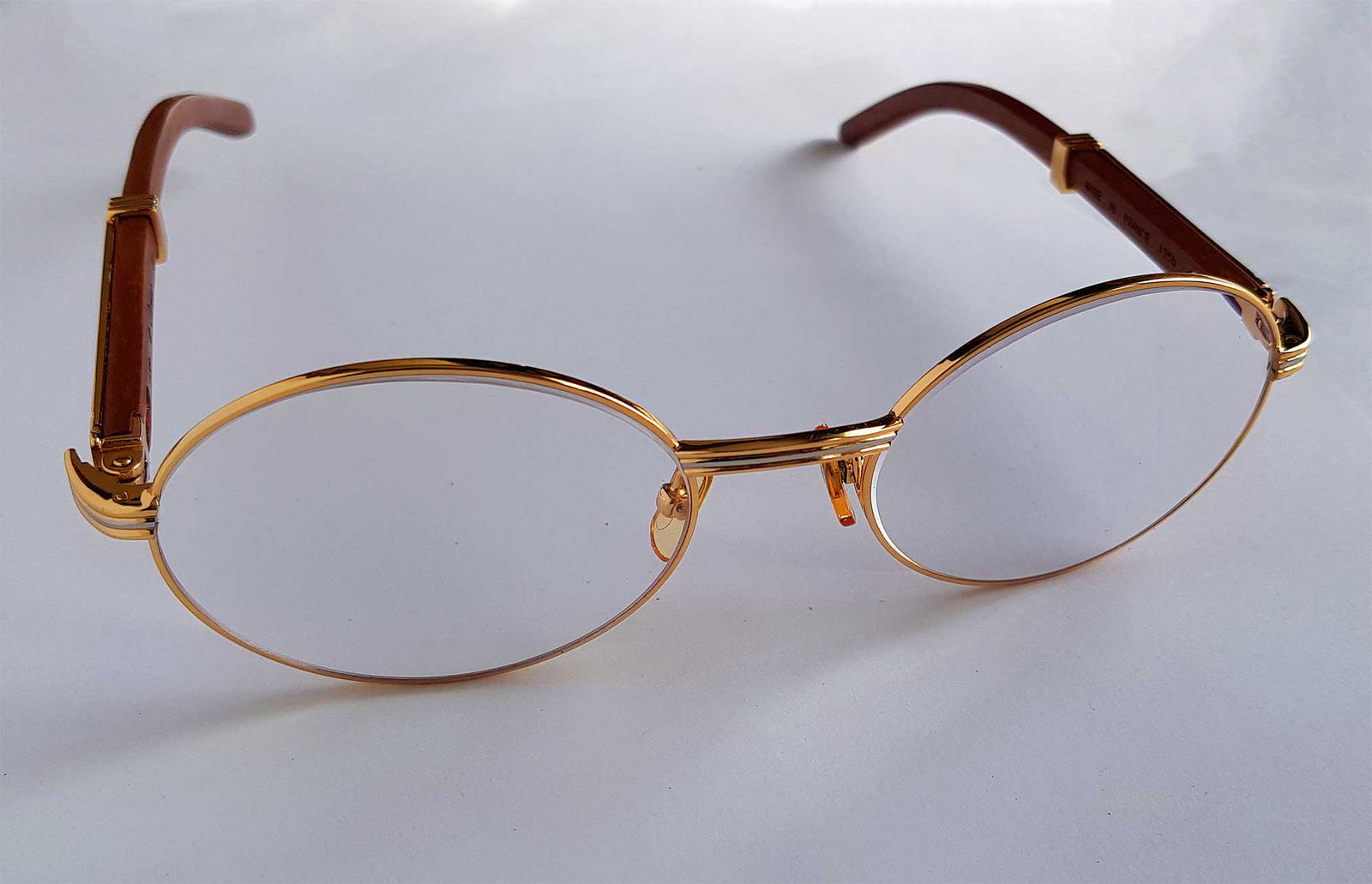 AUTHENTIC CARTIER BUBINGA EYE GLASSES, 24 KARAT: AUTHENTIC CARTIER BUBINGA EYE GLASSES, 24 KARAT Original Cartier gilded eye glasses. CONDITION: Excellent. The item is described to the best of our knowledge. Please refer to pictures and email with a