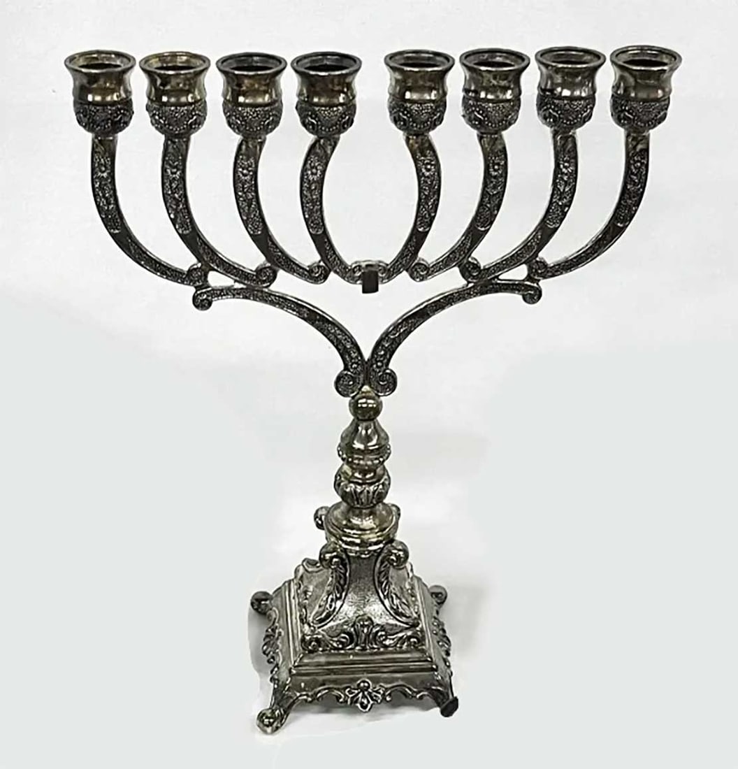 ANTIQUE JUDAICA HANUKKAH LAMP, MENORAH: ANTIQUE JUDAICA HANUKKAH LAMP, MENORAH An impressive Hanukkiah to celebrate Hanukkah, decorated with a stylized foliate design and featuring a spreading vase raised on four elegant scroll feet. The me