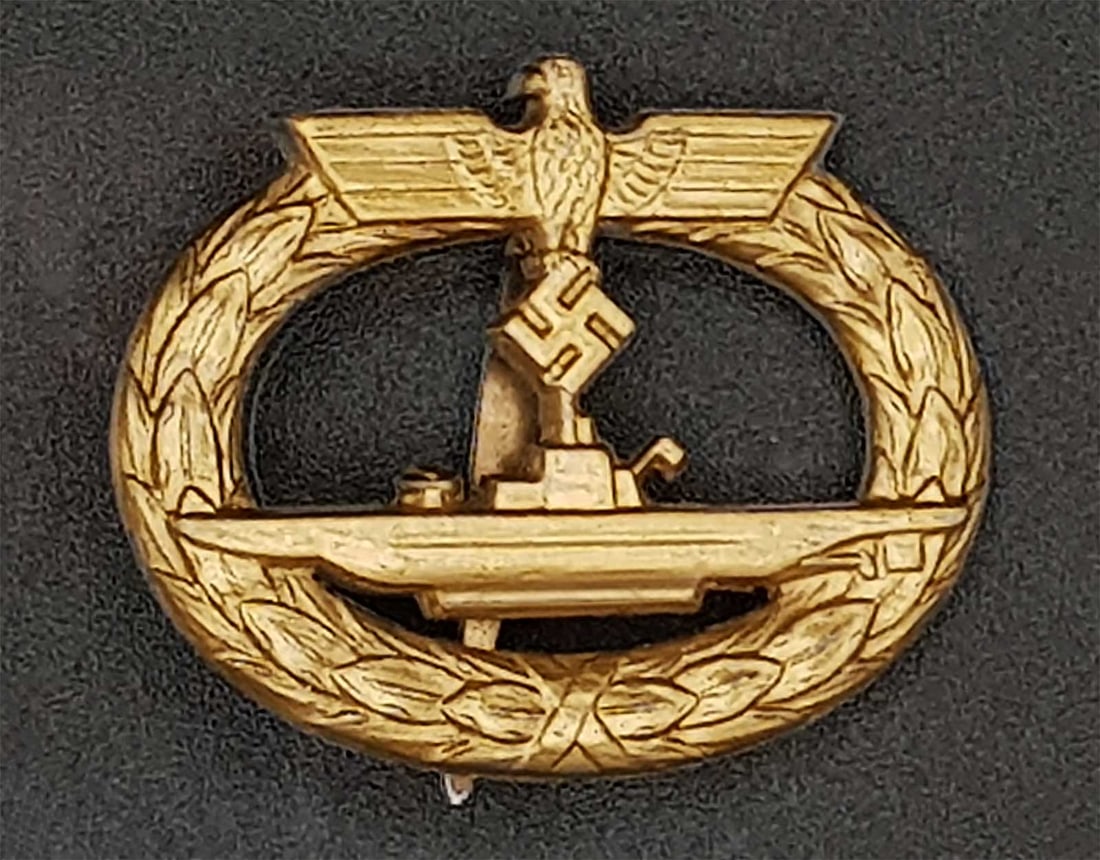 GERMAN WWII KRIEGSMARINE U-BOAT BADGE: GERMAN WWII NAVY KRIEGSMARINE U-BOAT WAR BADGE This is a German WWII Navy Kriegsmarine U-Boat War Badge produced from 1942 to 1945. It is made of gilded zinc and features a solid swastika, a single hi