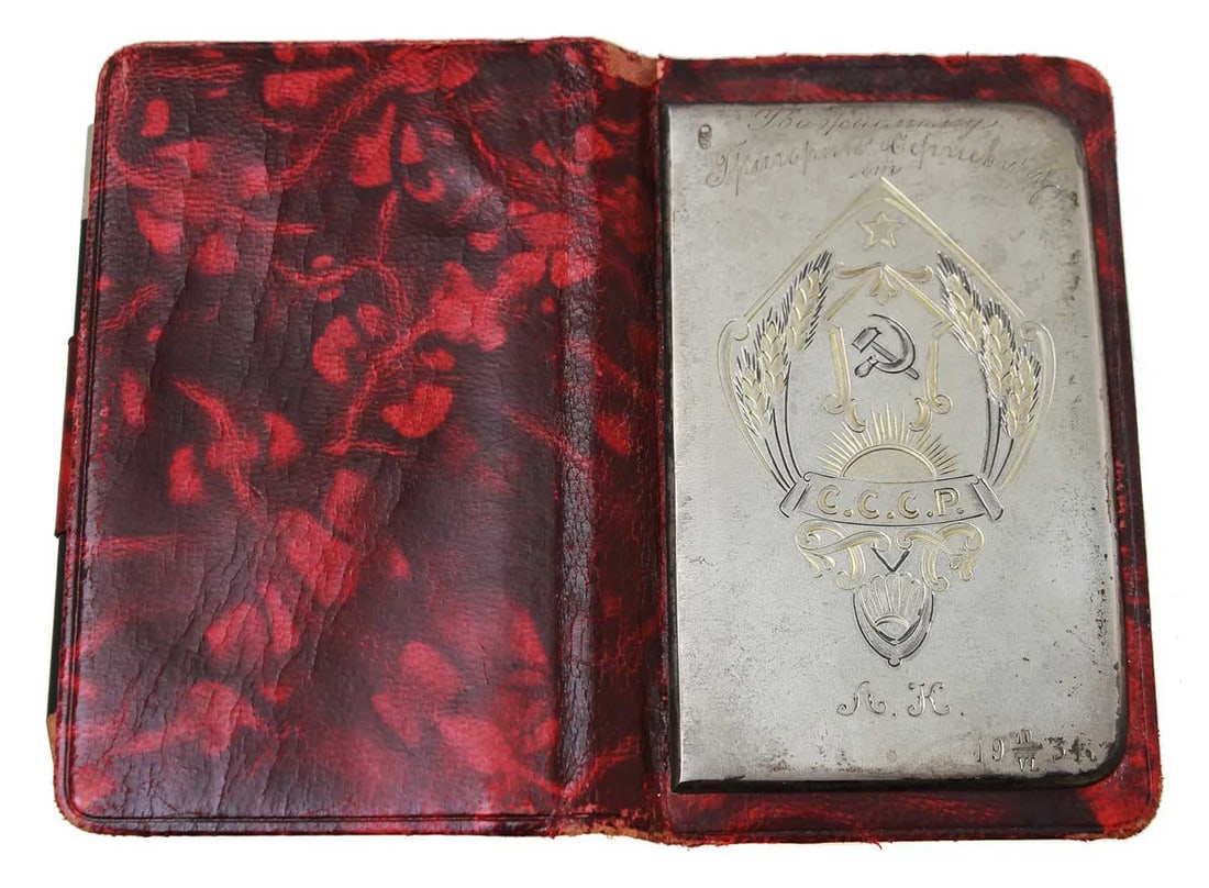 RUSSIAN SILVER PATRIOTIC NOTEPAD, ENGRAVED, 1931: RUSSIAN SILVER PATRIOTIC NOTEPAD, ENGRAVED, 1931 A Russian Soviet patriotic pad from 1931 in a red leather wrapper with a silver plate decorated with gilding. It is engraved with the coat of arms of t