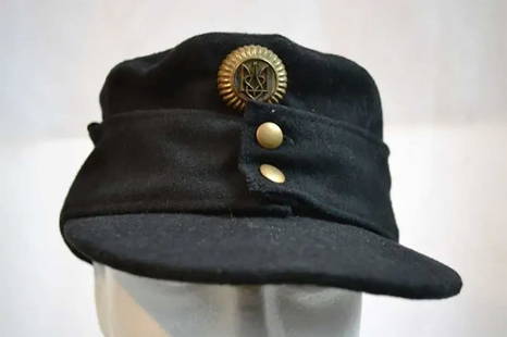 UKRAINIAN WWII NATIONALIST HAT w. BADGE: EXTREMELY RARE GERMAN-UKRAINIAN WWII NATIONALIST HAT with BADGE WWII black wool German-made Ukrainian nationalist hat. This black panzer wool m43 hat, made by Pecuro, is in size 5 and was converted by