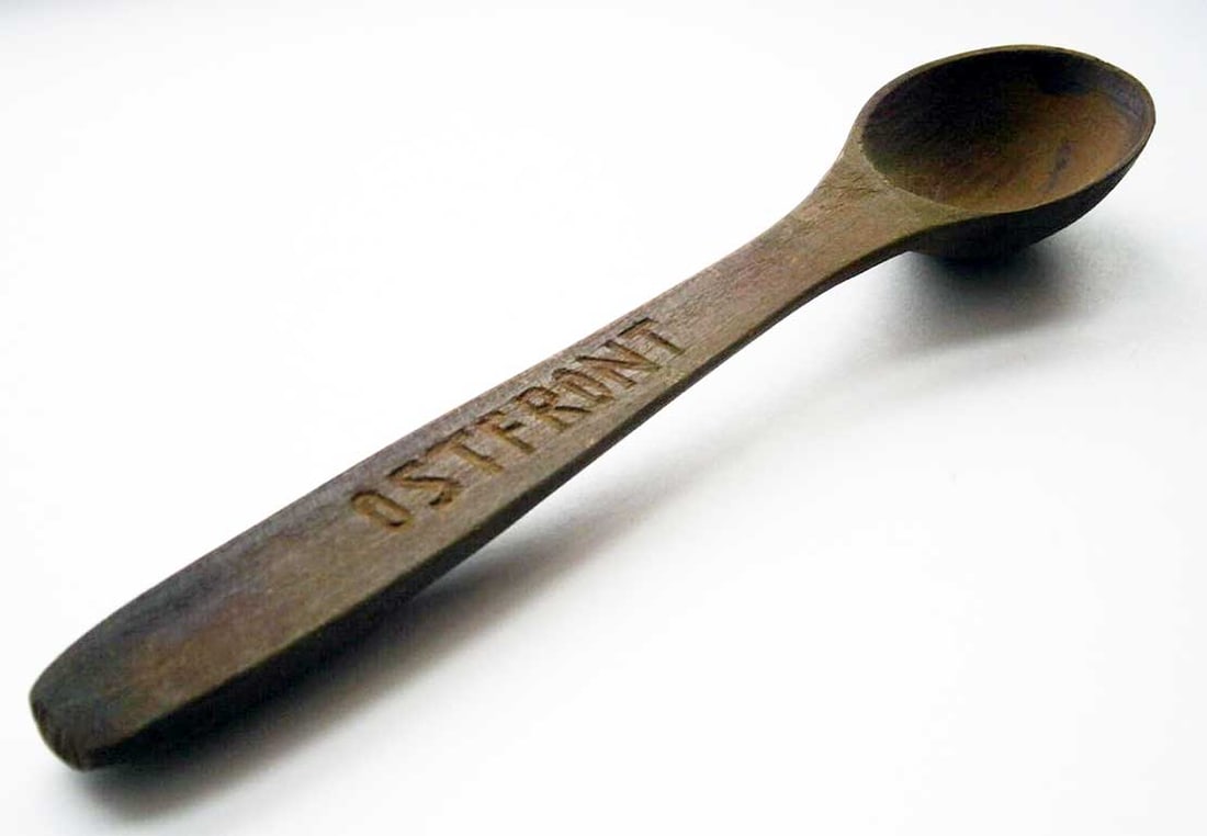 GERMAN WWII SPOON fr. EASTERN FRONT: Sale - Must Go ! GERMAN WWII SPOON from EASTERN FRONT This German WWII spoon from the Eastern Front features trench art and wood carving, with the word 'OSTFRONT' engraved on it. It comes from a genui