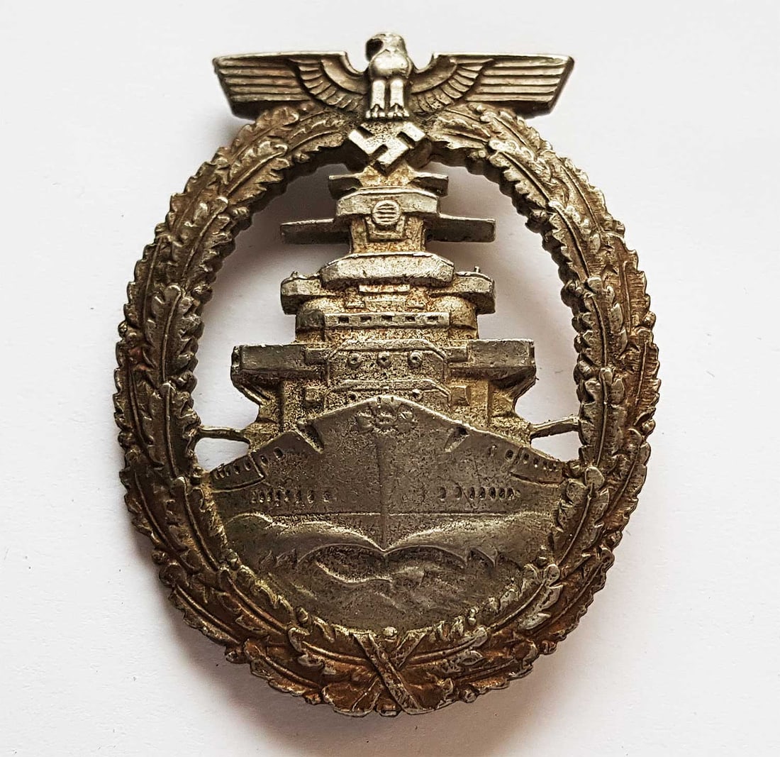 GERMAN WWII THIRD REICH HIGH SEAS FLEET BADGE: GERMAN WWII THIRD REICH HIGH SEAS FLEET BADGE German WWII Third Reich High Seas Fleet badge, made of tombak, produced from 1942 to 1945, featuring a vertical pin back and constructed from nickel with 