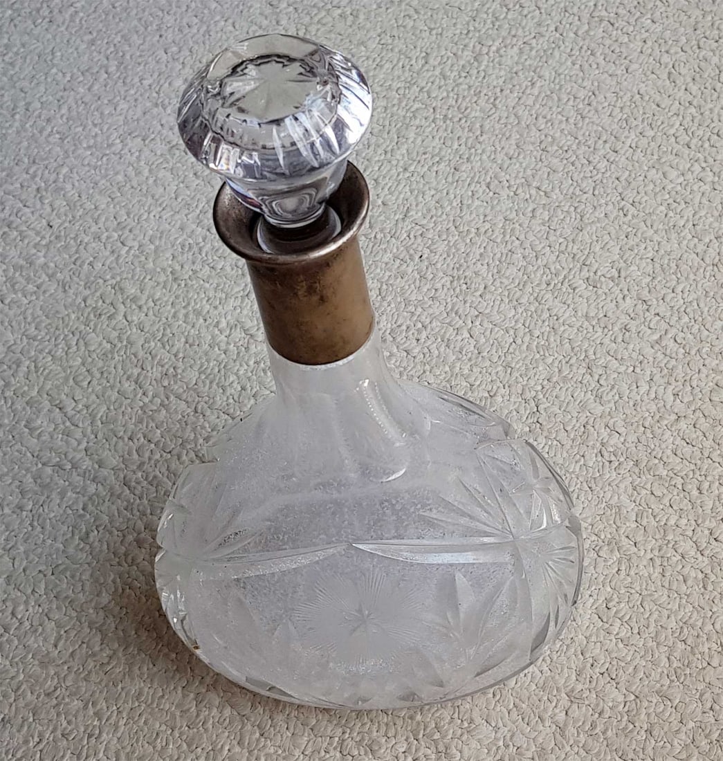 GERMAN SILVER & ETCHED GLASS DECANTER w. STOPPER, 1887: GERMAN SILVER and ETCHED GLASS DECANTER with STOPPER, 1887 This is an antique German 800 silver cut-glass decanter with a stopper. It features a round body with a floral design, an elongated neck, and