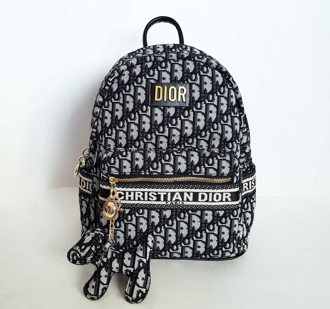 CHRISTIAN DIOR BACKPACK: DIORTRAVEL BACKPACK DIOR OBLIQUE JACQUARD Backpack Crafted in Dior Oblique jacquard, it is embellished with a Christian Dior Paris signature on the front. The large zipped flap opens with ease to acce