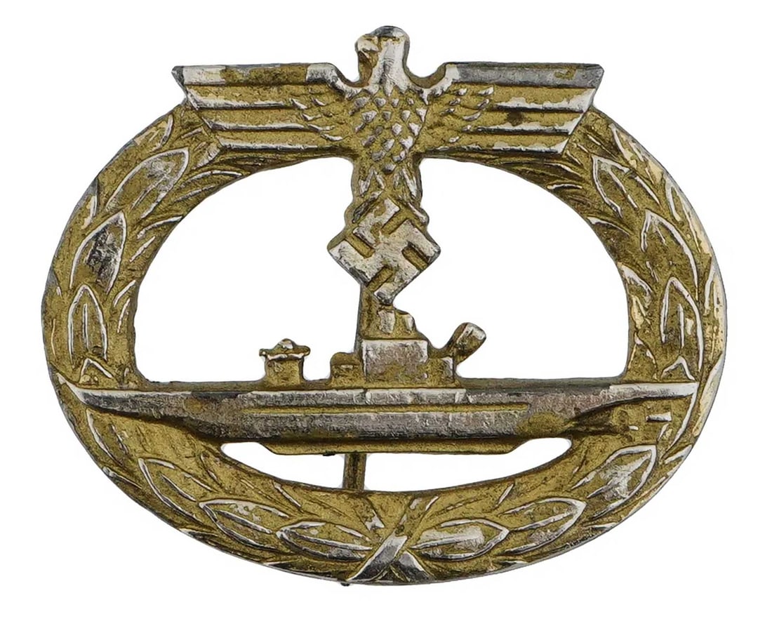 GERMAN WWII KRIEGSMARINE U-BOAT BADGE: Rare and Collectible! GERMAN WWII KRIEGSMARINE U-BOAT BADGE Zinc, gilded, unmarked. Vertical needle pin, solid swastika, short dome-head, wire catch. Attribyted to Foerster & Barth of Ludenscheid. CON