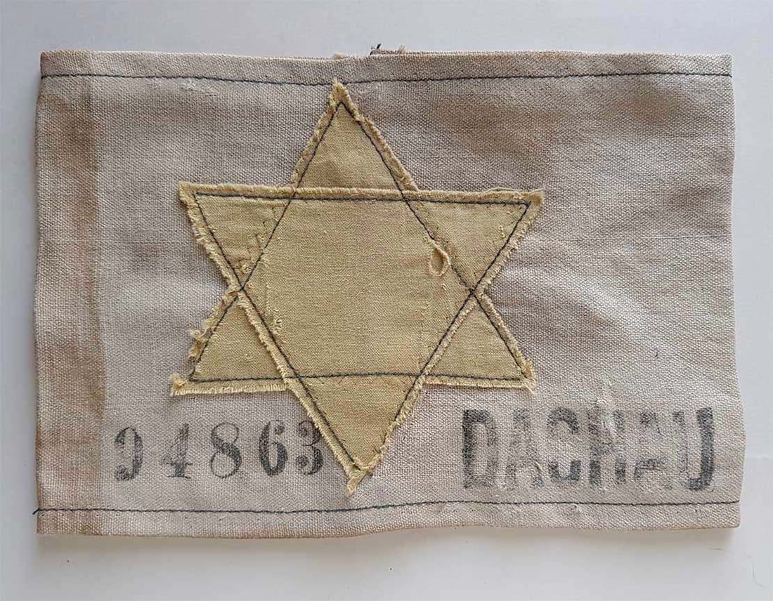 JEWISH WWII ARMBAND w. YELLOW DAVID STAR: Great Display Piece! JEWISH WWII ARMBAND with YELLOW DAVID STAR from DACHAU CONCENTRATION CAMP This rare WWII-era concentration camp armband features a yellow Star of David, the symbol imposed by the 