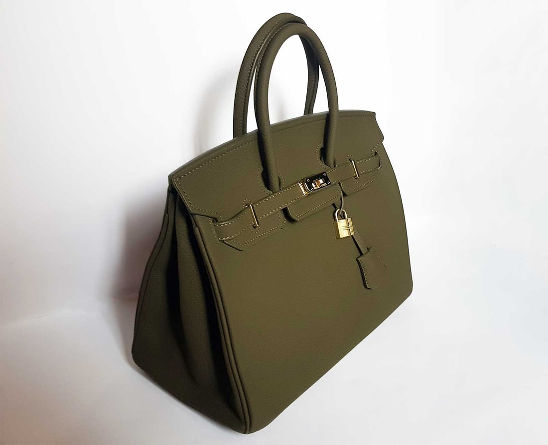 HERMES BIRKIN BAG 35 OLIVE GREEN: HERMES OLIVE GREEN TOGO LEATHER 35 cm BIRKIN BAG The handbag that has become a staple for women that are "high society" is the Hermes Birkin. Hermes Birkin bags are one of the most sought after