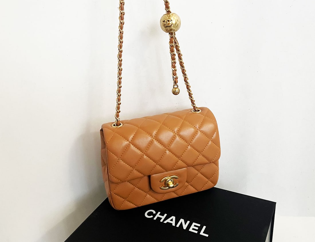 CHANEL CARAMEL PEARL CRUSH SQUARE FLAP BAG: CHANEL CARAMEL PEARL CRUSH MINI SQUARE FLAP BAG GOLD TONE HARDWARE This is a beautiful classic mini square is of caramel lambskin with gold tone hardware and has a front flap with signature CC