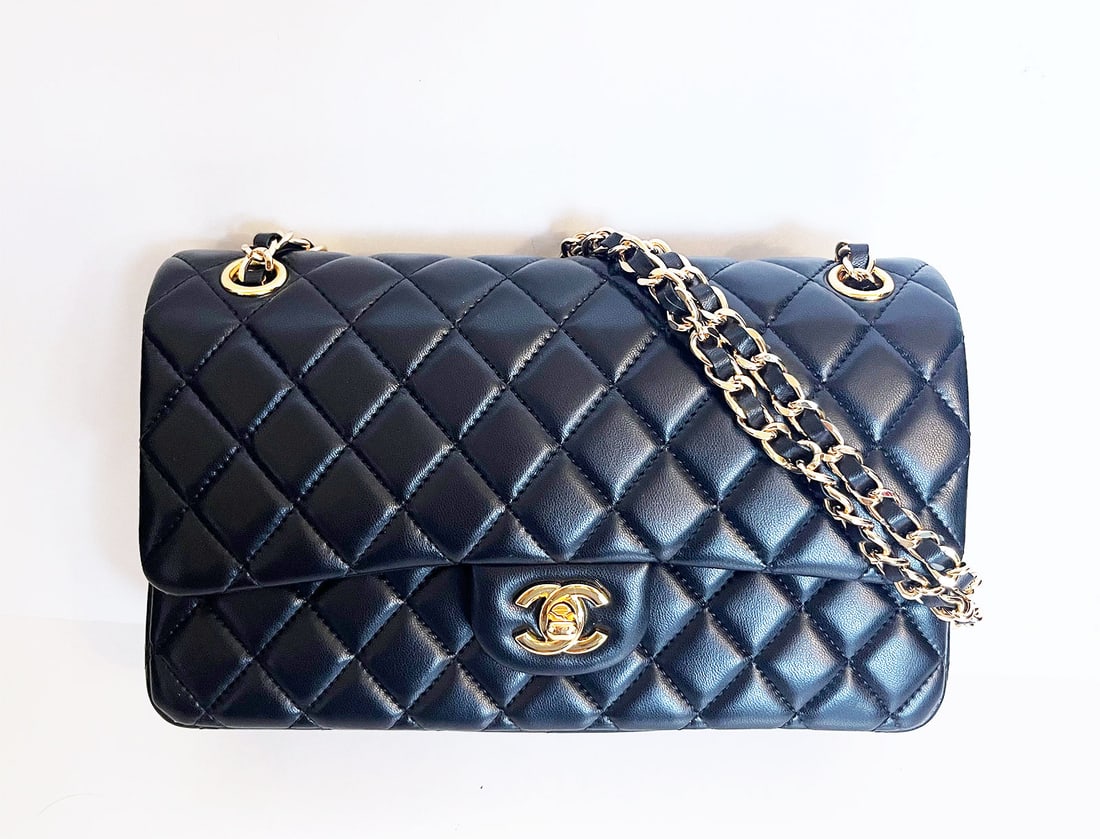 CHANEL CLASSIC DOUBLE FLAP MEDIUM: CHANEL TIMELESS MEDIUM DOUBLE FLAP SHOULDER BAG in BLACK This exceptional Chanel Timeless medium double-flap shoulder bag is crafted from quilted black leather. Gold-tone hardware and a metal chain ha