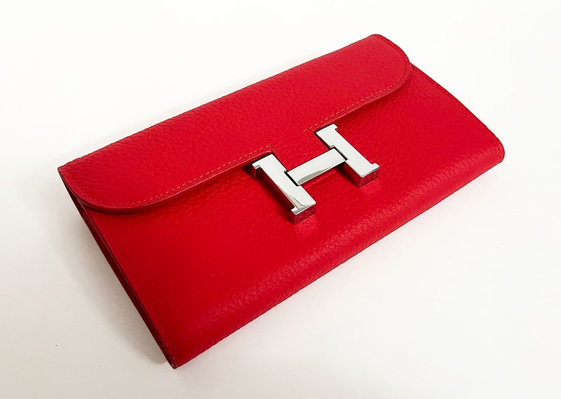 HERMES LONG WALLET RED: HERMES CONSTANCE TO GO WALLET BLACK EPSOM This is HERMES Long Wallet in Red. This chic wallet is crafted of fine calfskin leather in black. It features a front flap and signature press lock. This