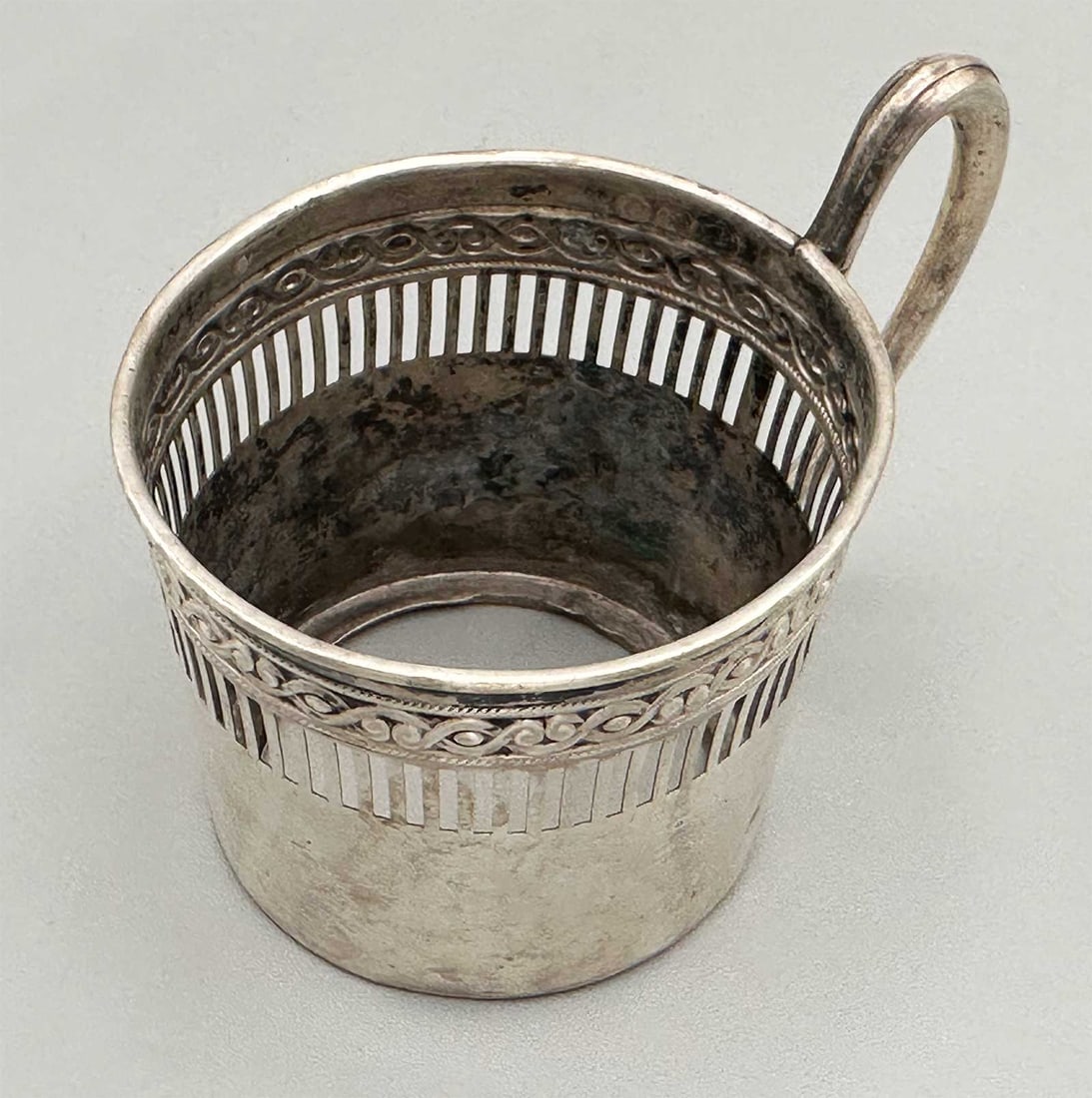 GERMAN SILVER TEA GLASS HOLDER: Price Reduced — Limited-Time Offer! GERMAN SILVER TEA GLASS HOLDER For your viewing pleasure, here is a cylindrical vessel, with a loop handle. Hallmarked. PROVENANCE: 1. From an old collection, Tel