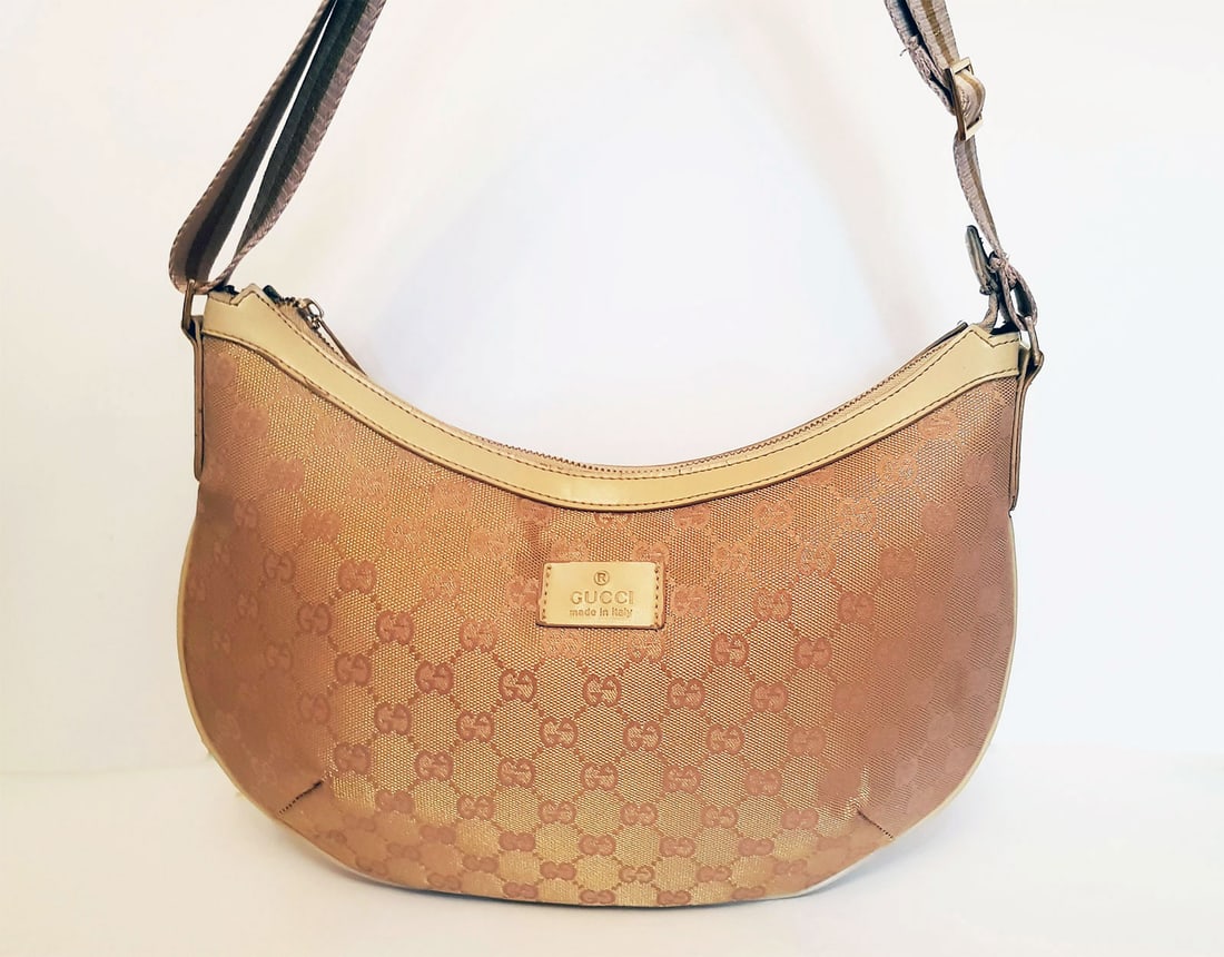 GUCCI HOBO LINEN CROSSBODY BAG: PRE-OWNED GUCCI GG CANVAS HALF MOON MEDIUM MESSENGER BAG This Gucci bag comes in a half moon shape and is crafted from metallic silver monogram canvas. The bag has a shoulder strap with gold color ha