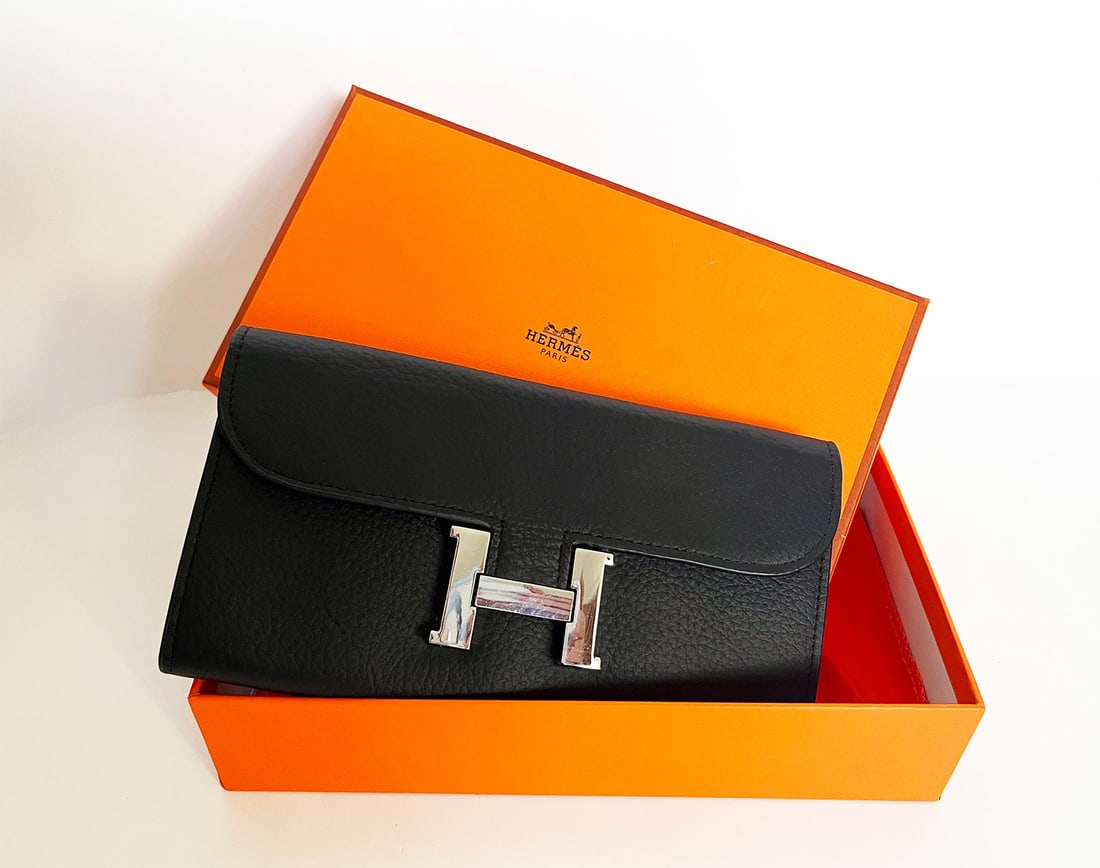 HERMES LONG WALLET BLACK: HERMES CONSTANCE TO GO WALLET BLACK EPSOM This is HERMES Long Wallet in Black. This chic wallet is crafted of fine calfskin leather in black. It features a front flap and signature press lock. This o