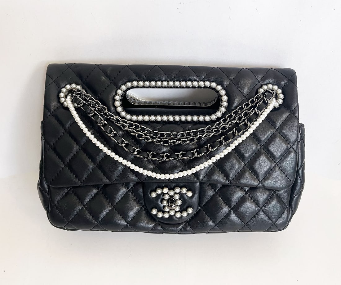 CHANEL MEDIUM WESTMINSTER FLAP BAG: CHANEL MEDIUM DOUBLE FLAP BAG with PEARL CUT OUT HANDLE BLACK LAMBSKIN BLACK HARDWARE This Chanel Double Flap with cut out handle is of black lambskin leather with black hardware embellished with faux