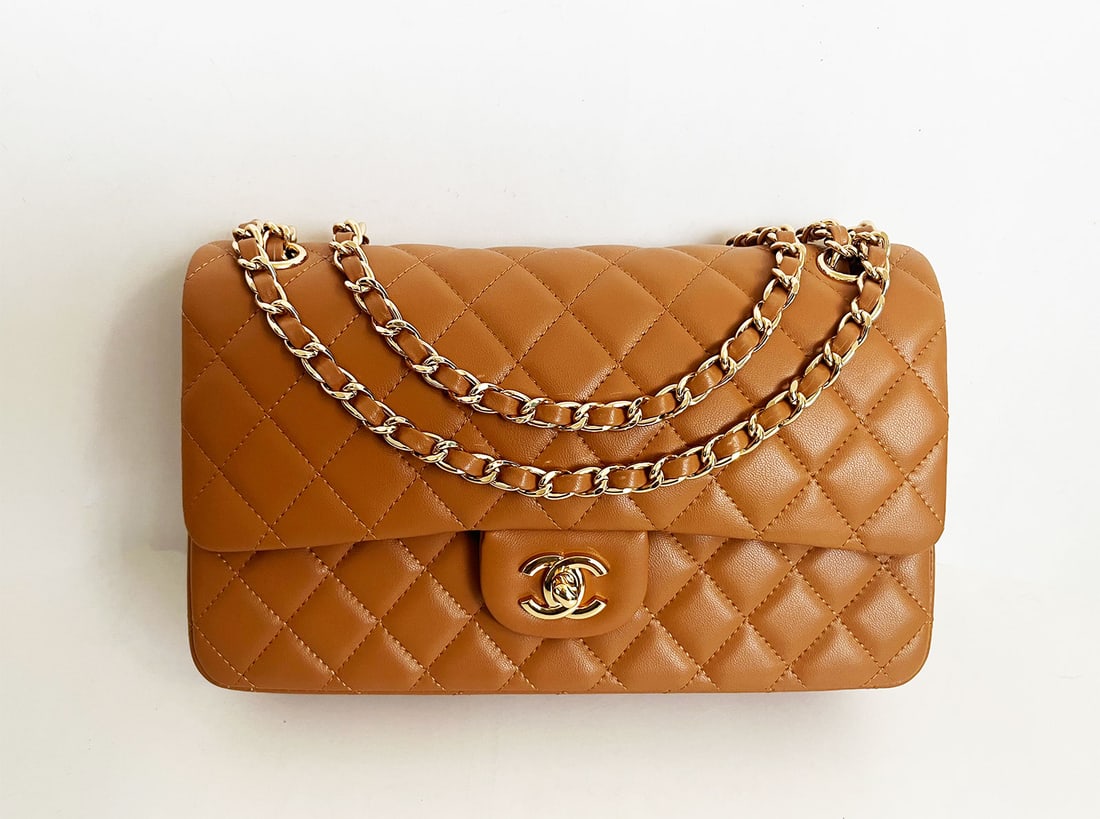 CHANEL CARAMEL CLASSIC FLAP BAG MEDIUM: CHANEL MEDIUM CLASSIC DOUBLE FLAP BAG CARAMEL LAMBSKIN LIGHT GOLD TONE HARDWARE A Chanel Caramel Classic Flap Bag to keep forever. This particular bag features a lovely quilted lambskin leather and al