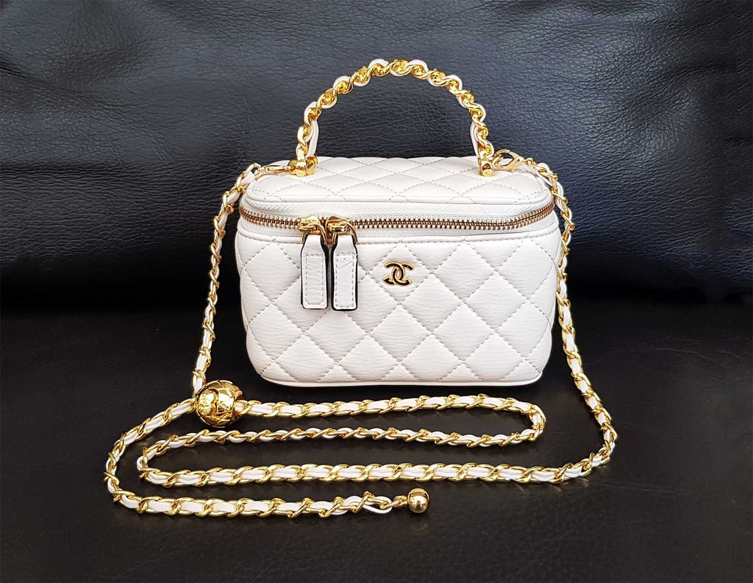 CHANEL SMALL VANITY CASE GOLD TONE HARDWARE: CHANEL SMALL VANITY CASE WHITE LEATHER GOLD TONE HARDWARE This Small Rectangular Classic Vanity Case is in white quilted leather with light gold hardware, tonal stitching, CC logo on front, a built-in